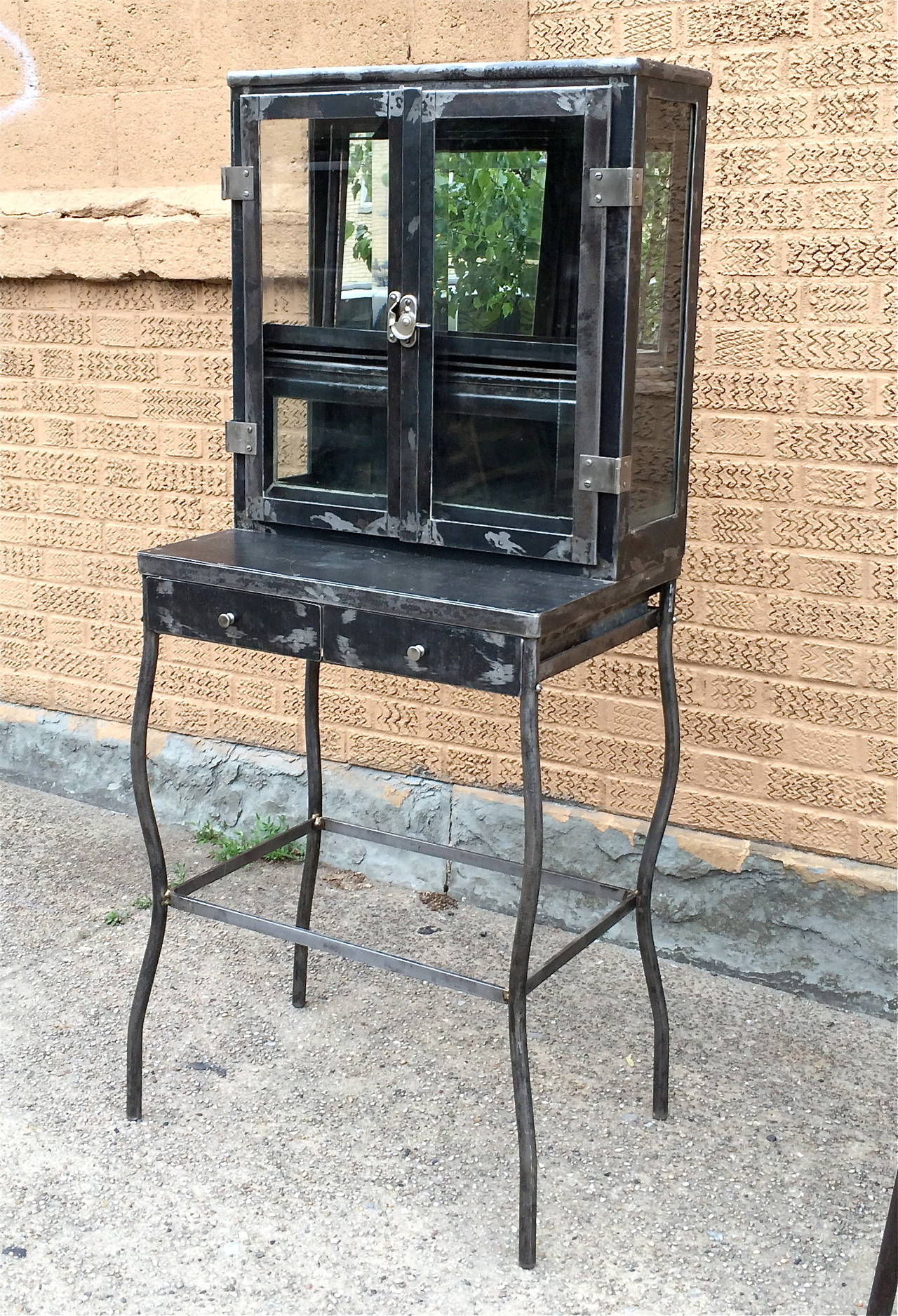 1930s, brushed steel, two drawer, apothecary, dentist medicine cabinet with three sided glass top cabinet with mirror backing and wood shelf. Top shelf depth is 7.5 inches.