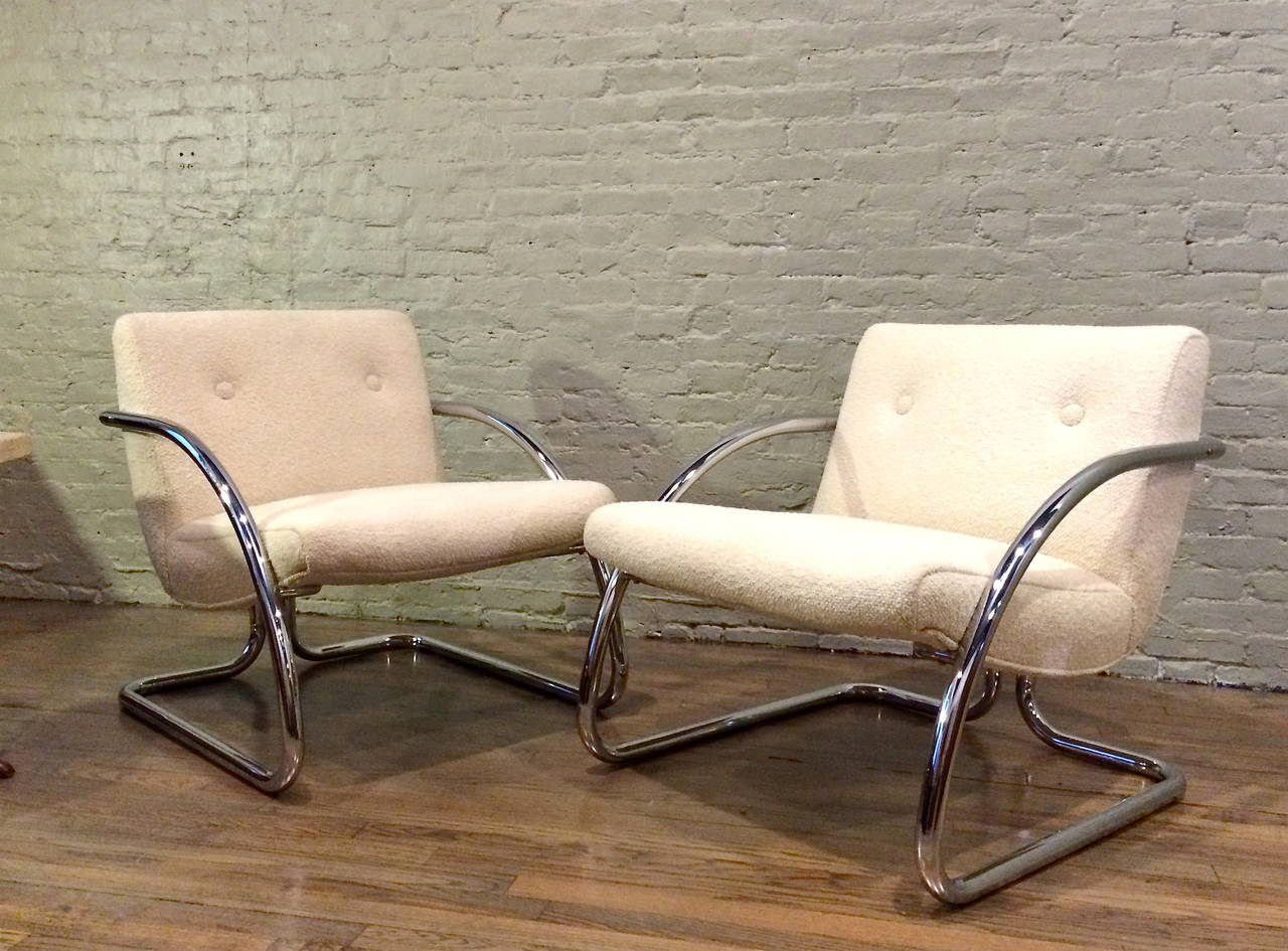 Pair of modern, 1970s, tubular chrome frame lounge armchairs with great lines are newly upholstered in a cream bouclé́ cotton rayon blend.