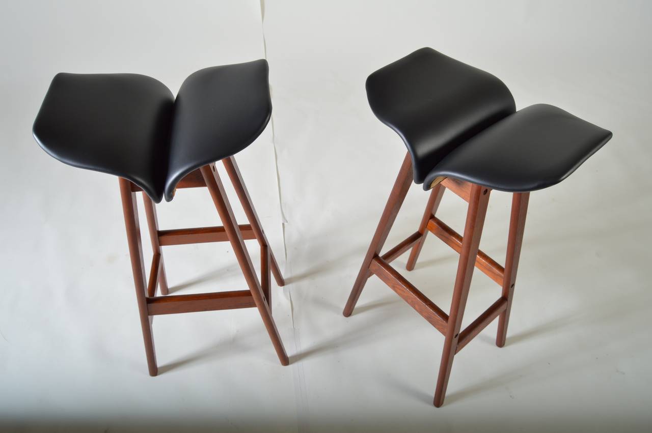 A pair of early teak barstools designed by Erik Buch. Unmarked.