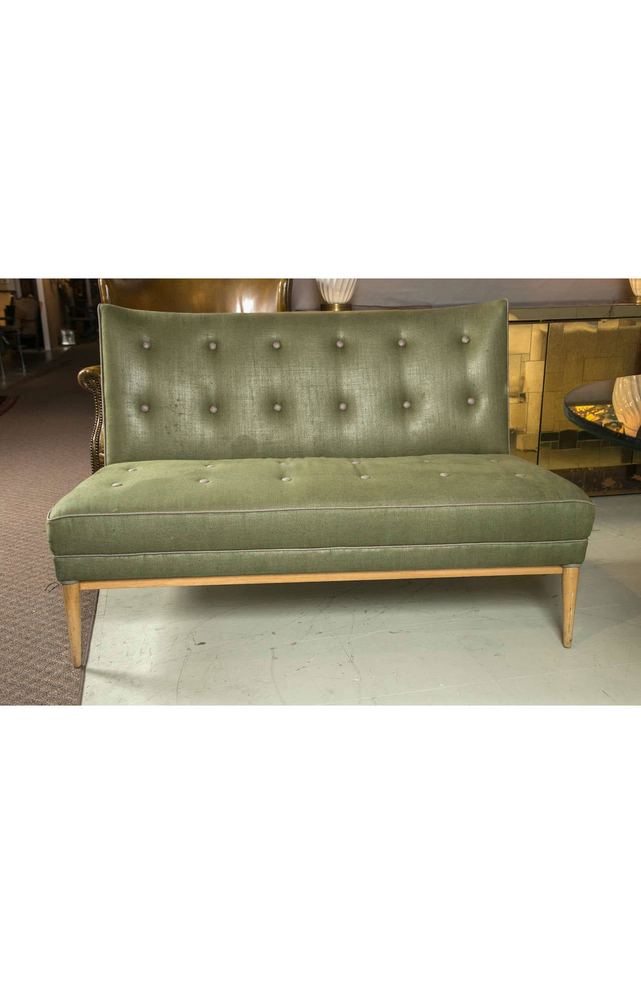 This handsome Paul McCobb settee is reupholstered in rich green linen with gray piping and button tufting. Pale-yellow birch wood base and legs are a beautiful complement to this palette. The 9