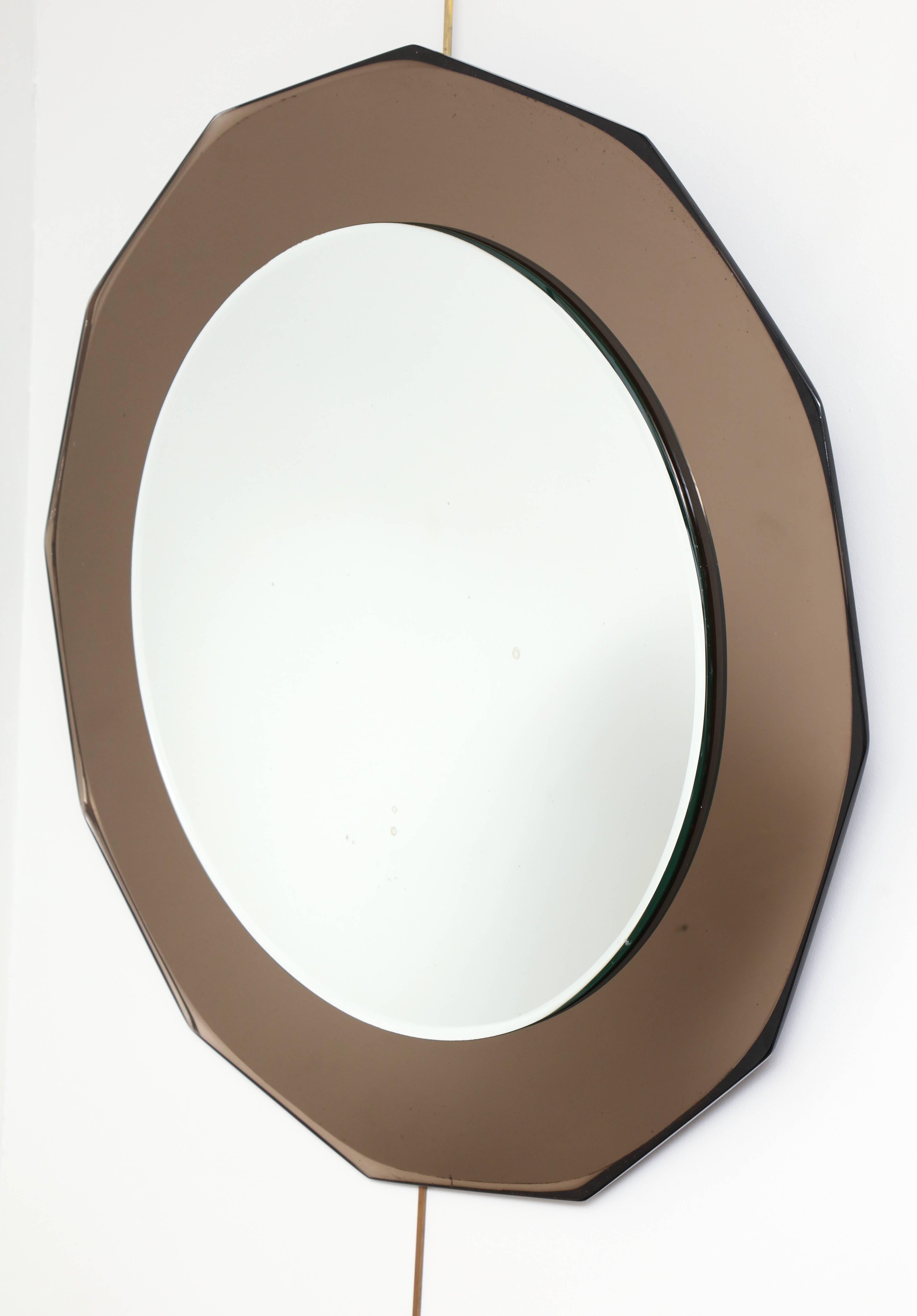 Mid-20th century circular mirror, tinted shaped borders.