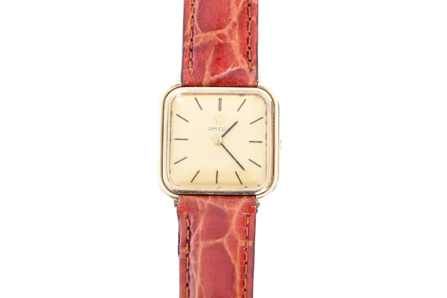14K gold "Omega" circa 1960. The band is genuine leather, in a ochre hue. Length: 9", Square Face: 1.00"