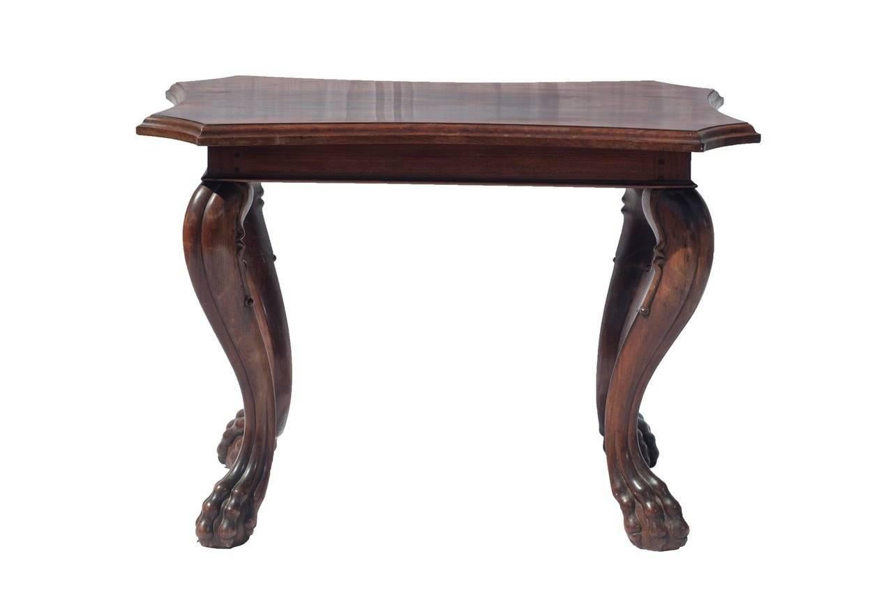 A colonial mahogany side table with claw feet.