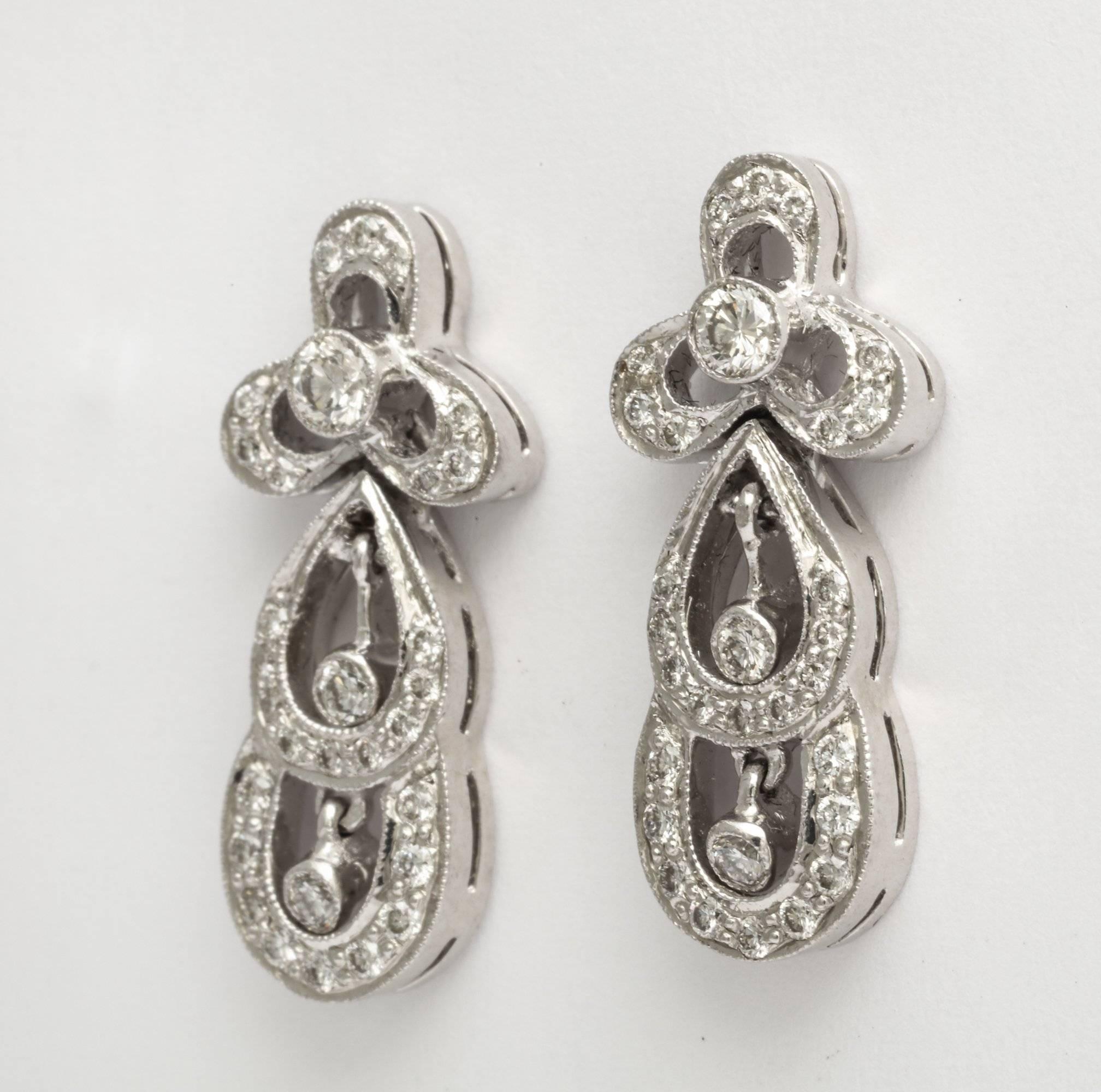 A delicate pair of French Deco diamond drop earrings set in platinum with two small dangling diamond drops in each. French touch marks. 