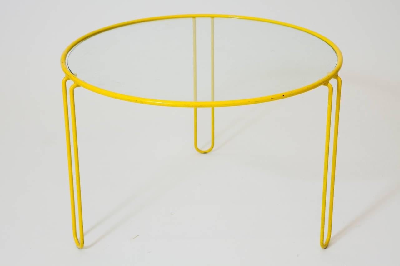 A set of three yellow painted wrought iron side tables with glass tops.
Measures: Small 20 in diameter x 12 in high
Medium: 22 in diameter x 15 in high
Larger: 24 in diameter x 16 in high
Sold as a set.
