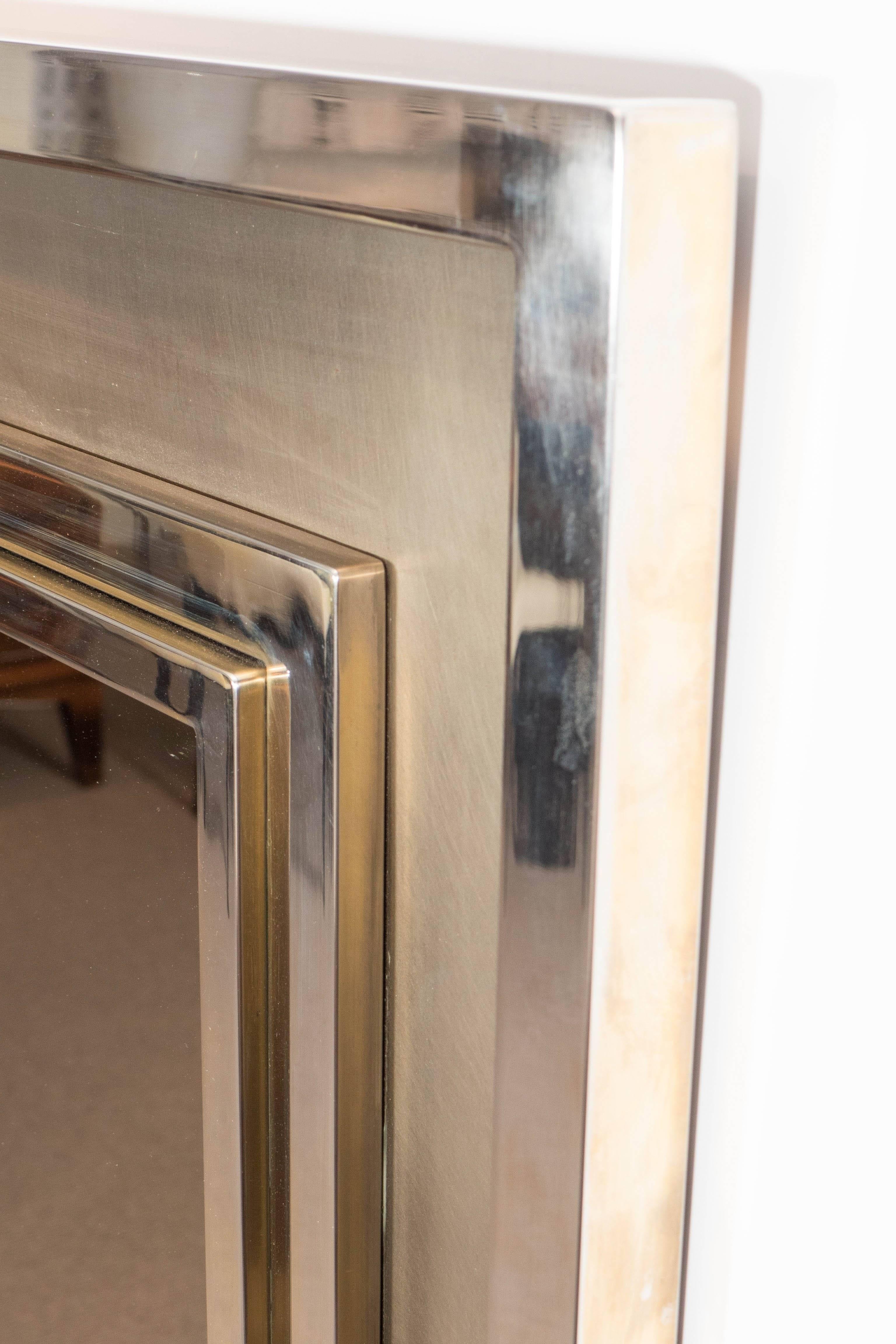 Polished chrome mirror with polished and satin brass inner frame.