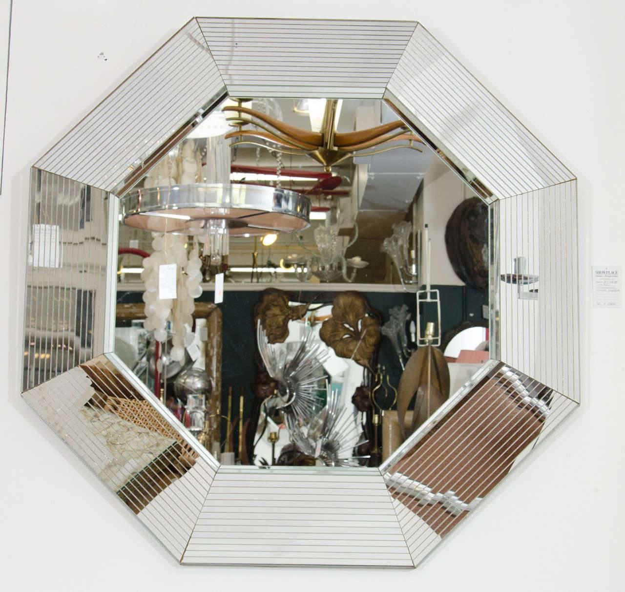 This is an incredible vintage '70s Modern or Post-Modern [Postmodern] period octagonal wall mirror in the style of designer Karl Springer. A very beautiful and large mirror; a special mirror, a statement piece from the 1970s Disco era New York.