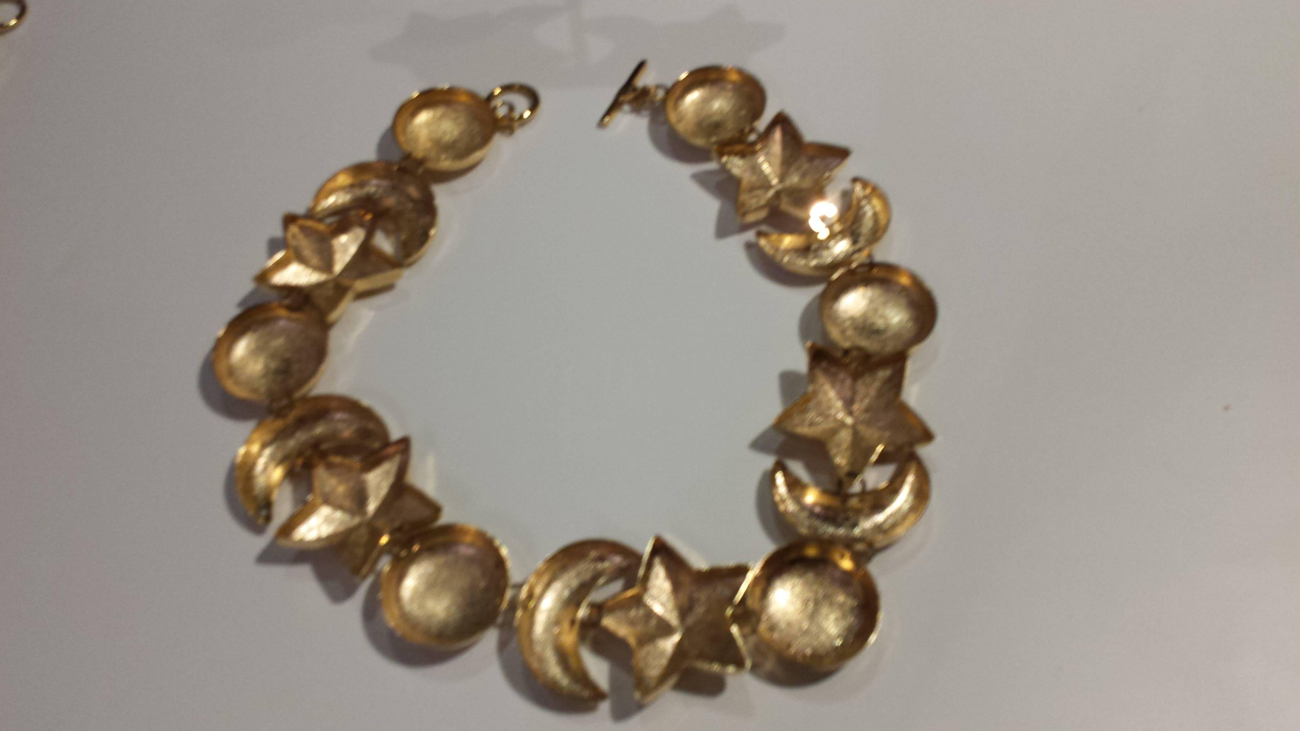 Stunning chunky four pieces. Set of inspired celestial design from Dior, unmarked- necklace, bracelet and earrings gold tone textured metal.
This set is so much fun to wear, turn heads and garner compliments!

Provenance-purchased in Paris-from the