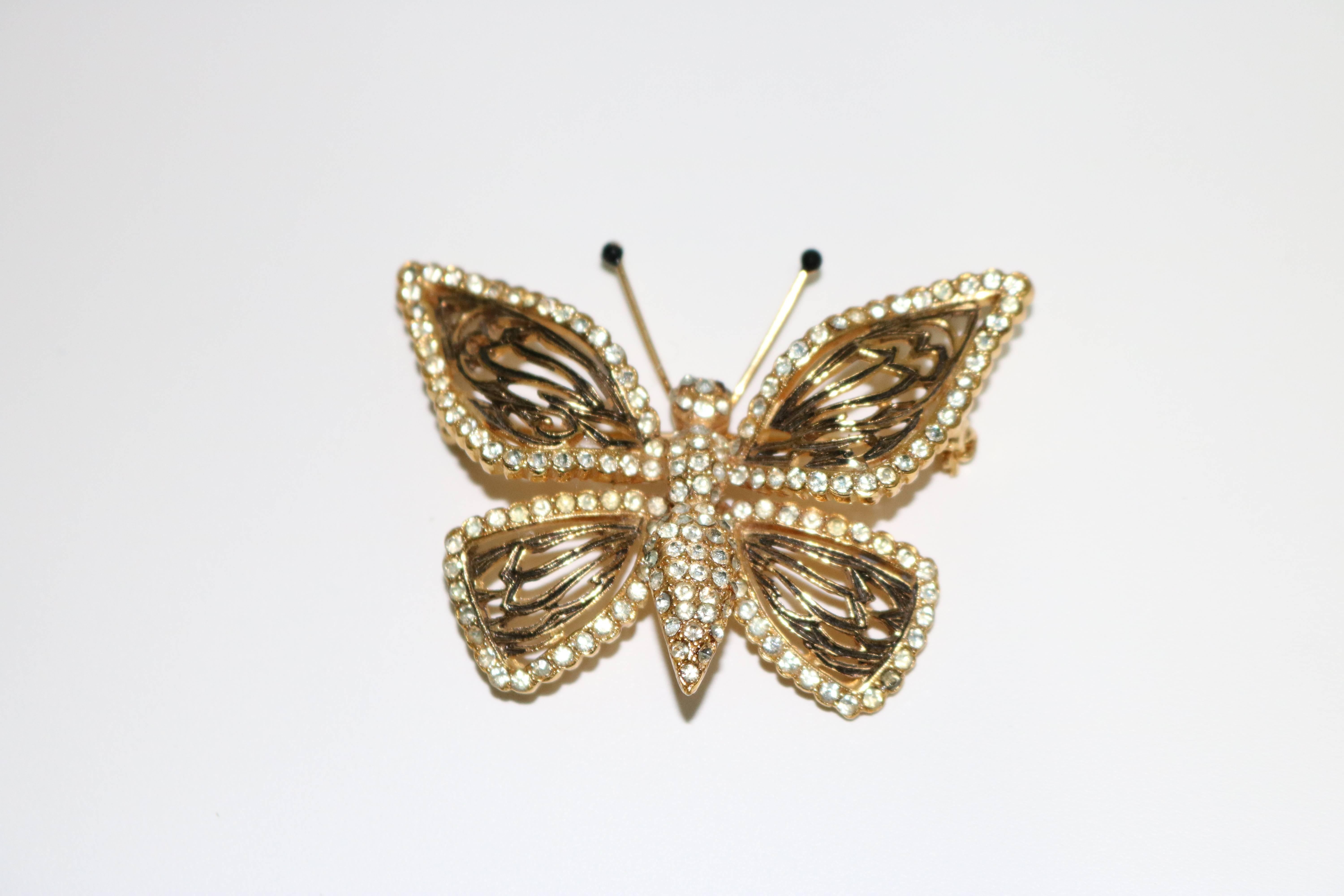 A lovely Gold Plate butterfly with diamante embellished wings and body, gold with black enameled articulated wings and black stone topped antennae with red stone eyes.  
Turns a moth into an Enchanting Butterfly!!

Marked en verso- Vogue