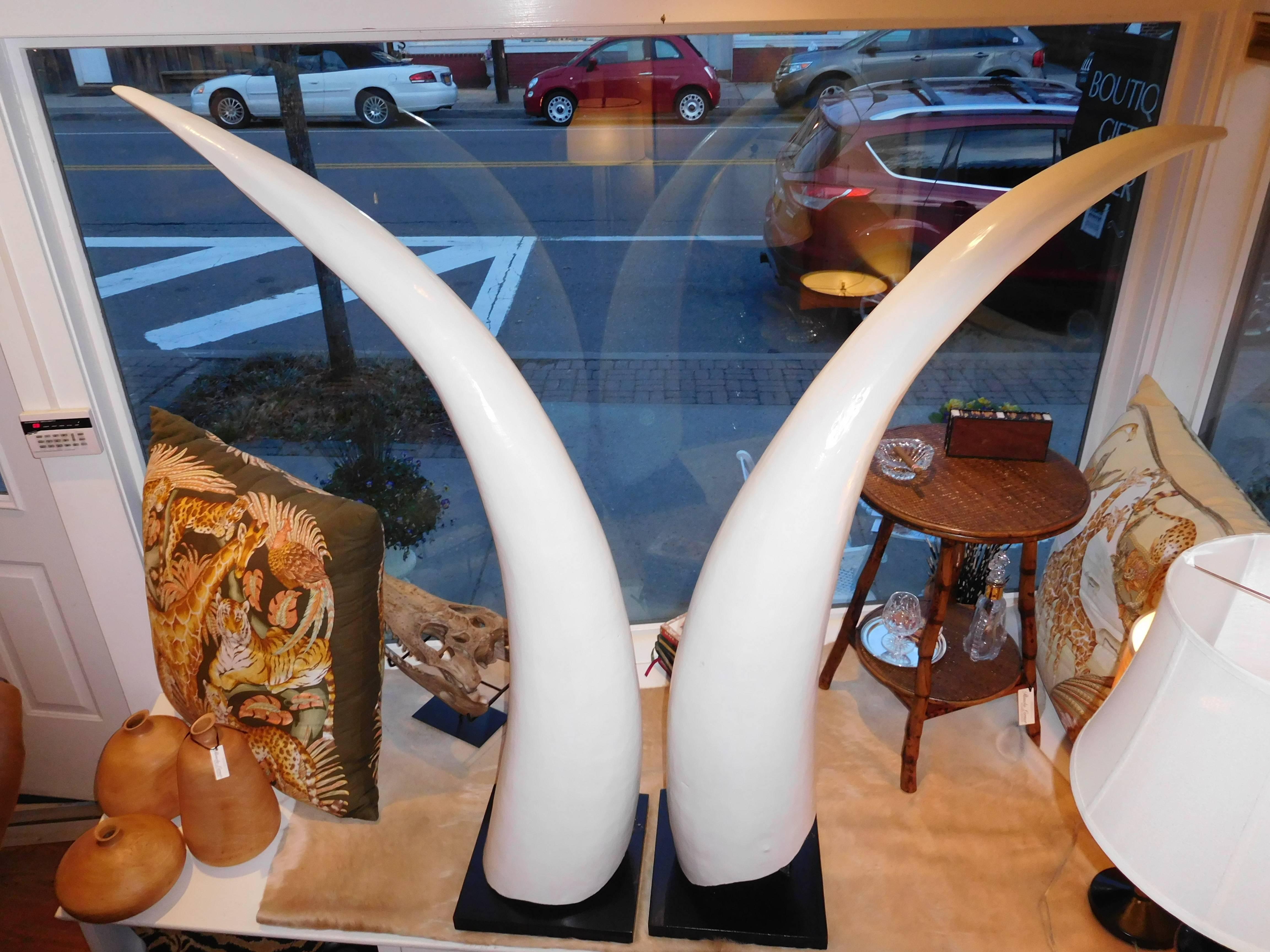 A towering and believable pair of hand-carved wooden elephant tusks by Franz Reich. There is no ivory content in these tusks (wood).
Set on a black lacquered wooden base showing the artist's inscription.
 (Franz Reich 1948 Sierra Leone West