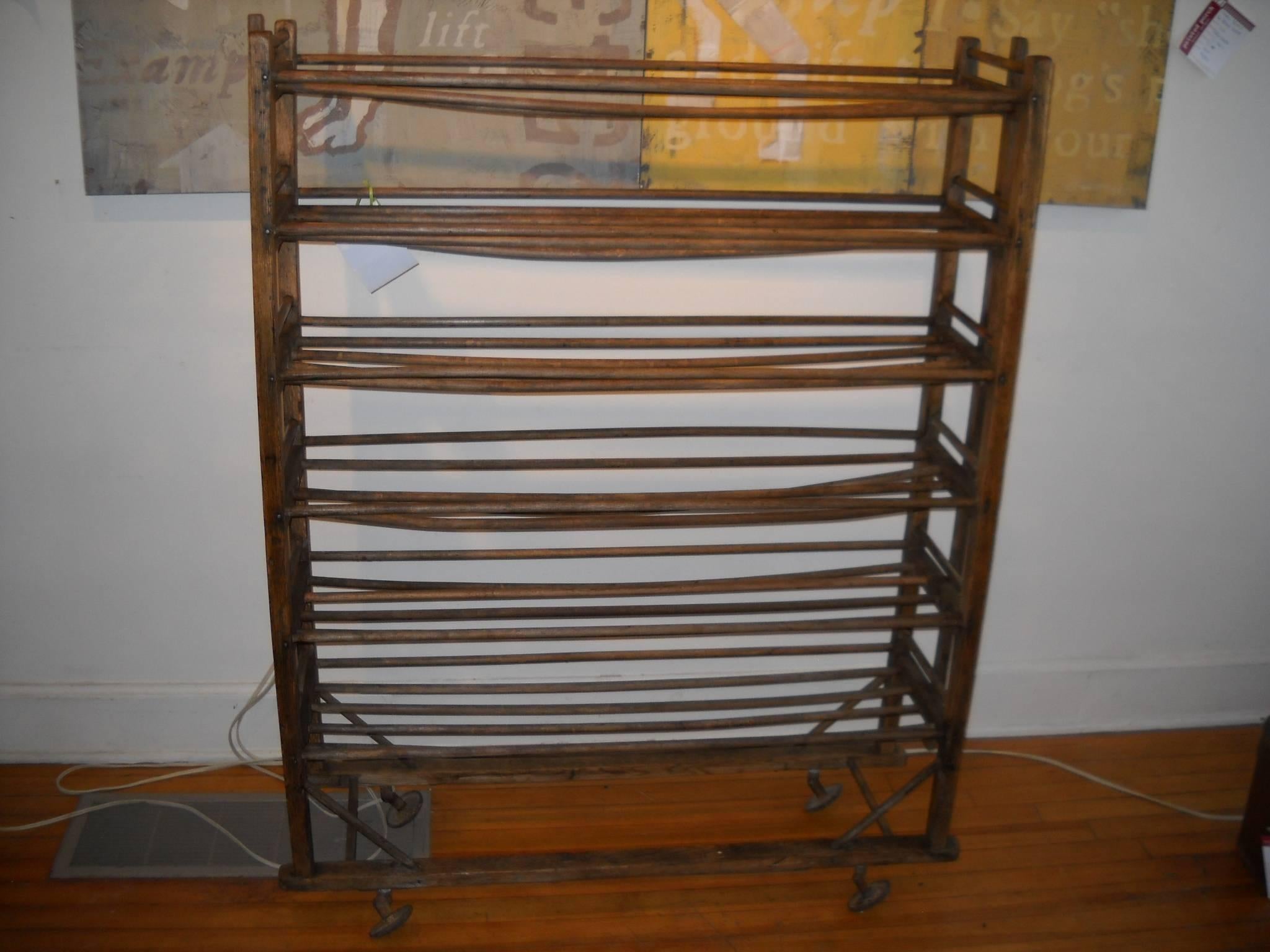 The English originally used these to dry shoes after making them. The French had the same item that were used as bakery racks. This particular piece has its original castors and they work wonderfully. This is a most useful piece that can be used to