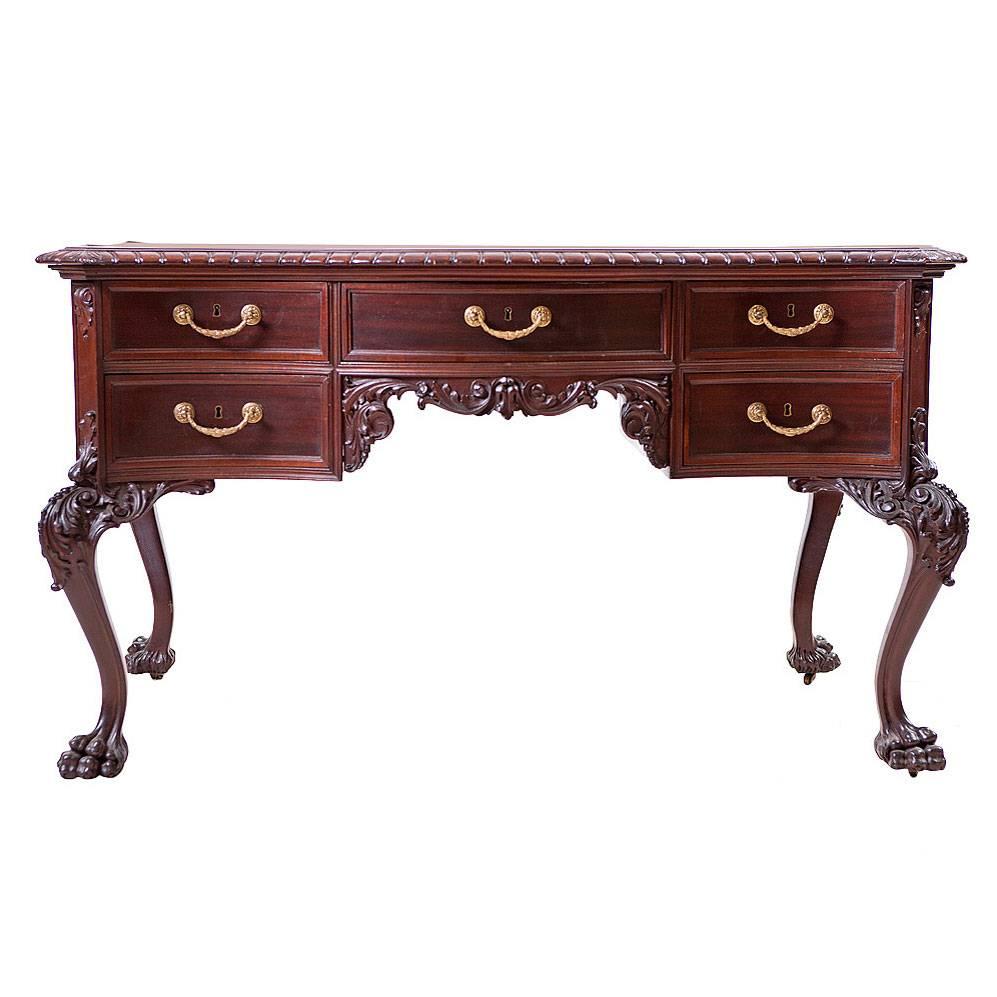 Philadelphia had a tradition of well-articulated carving in the late 1800s. This partners desk in a fine example of that tradition. It has the original decorative bales in fire gilded brass on both sides of the desk. Crafted of the finest mahogany,