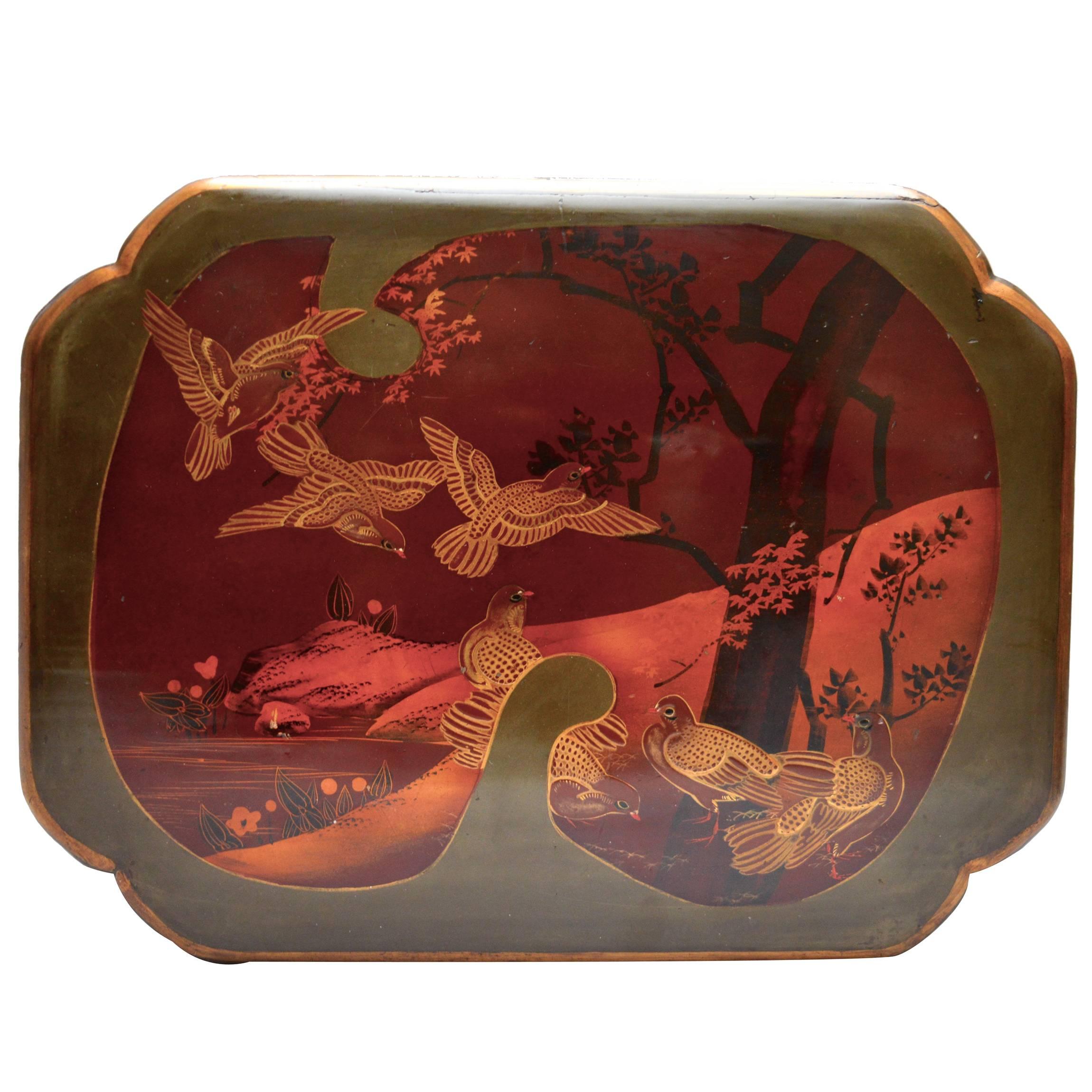 A Japanese Lacquered wood box in an elegant shaped design.
The exterior is decorated with a fine graphic scene which is created in different layers of smooth lacquer paint . 
The box has a detailed bronze fan decorated escheon and the original