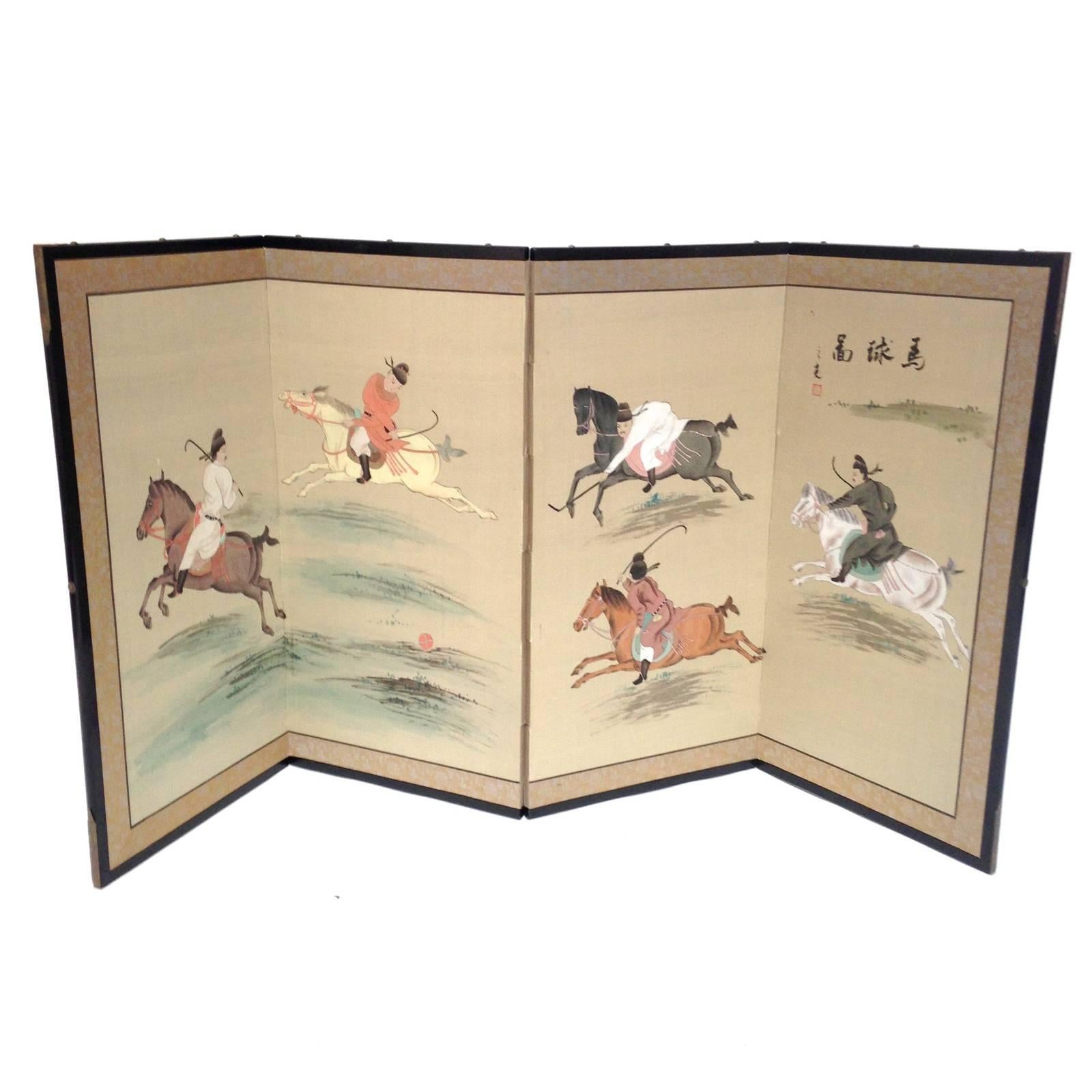 A rare, four panel folding Japanese equestrian byobu silk screen depicting five men on horseback playing a polo style game. A unique screen with painted panels and vibrant colors with an Hermes feel. It features an ebonized wood frame with brass