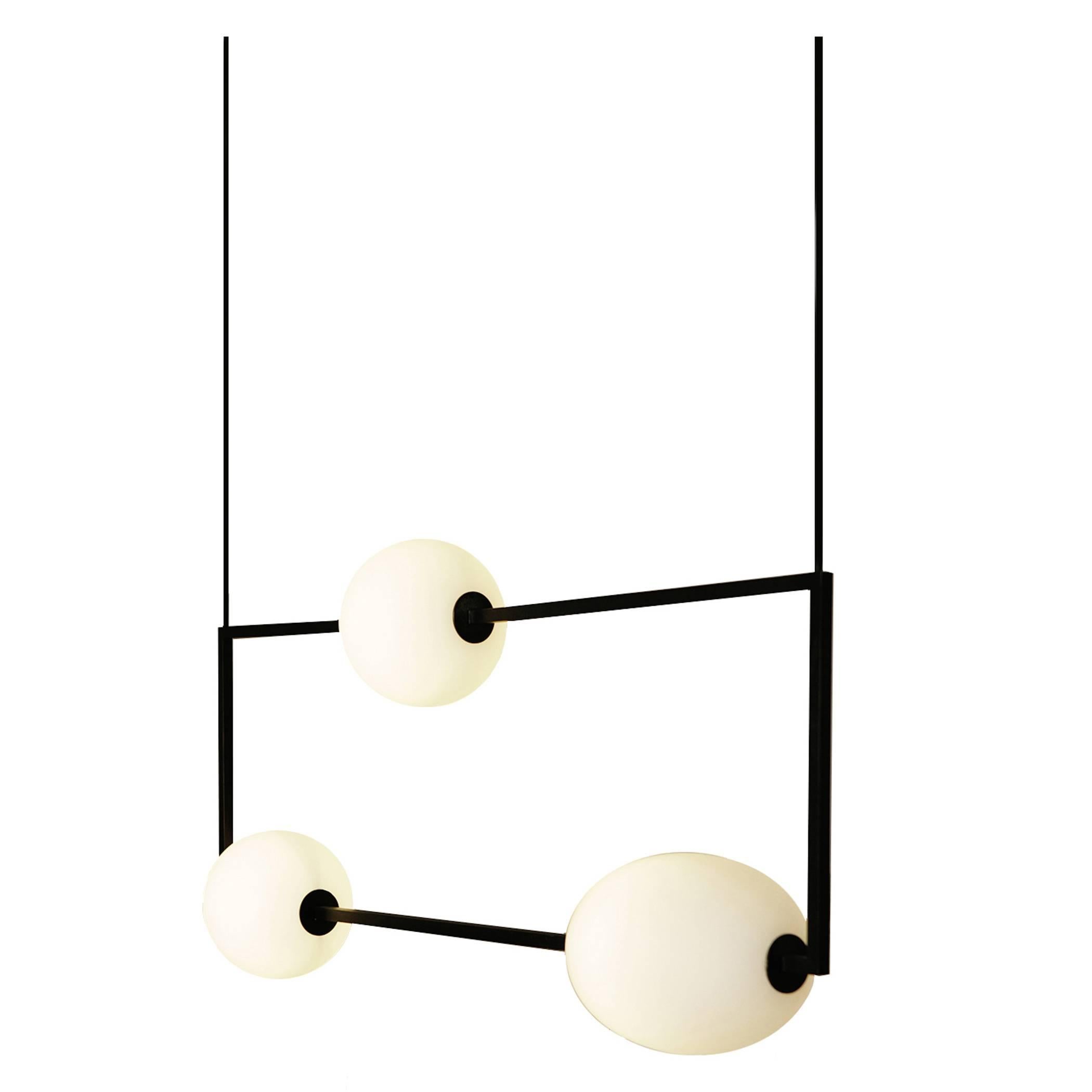 The Miro 3 is made of a single frame in a solid brass square stock. Finishes are blackened or unfinished brass. The glass shades are handblown, sand blasted and oiled. The wire is black cloth covered and can be ordered at a custom length. Hardware