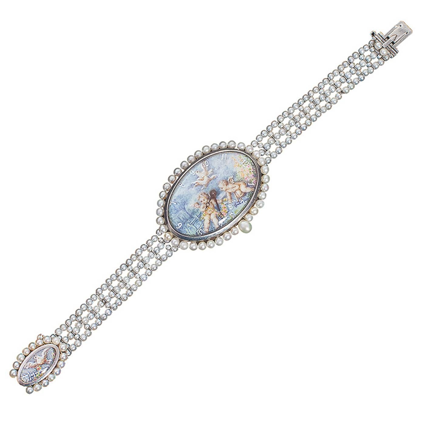 Phenomenal one of a kind French wristwatch centering a painted watch face of cherubs and doves in a lovely garden scene surrounded by natural pearls with a natural pearl winding stem. The clasp mirrors the face with a painted dove and a flower