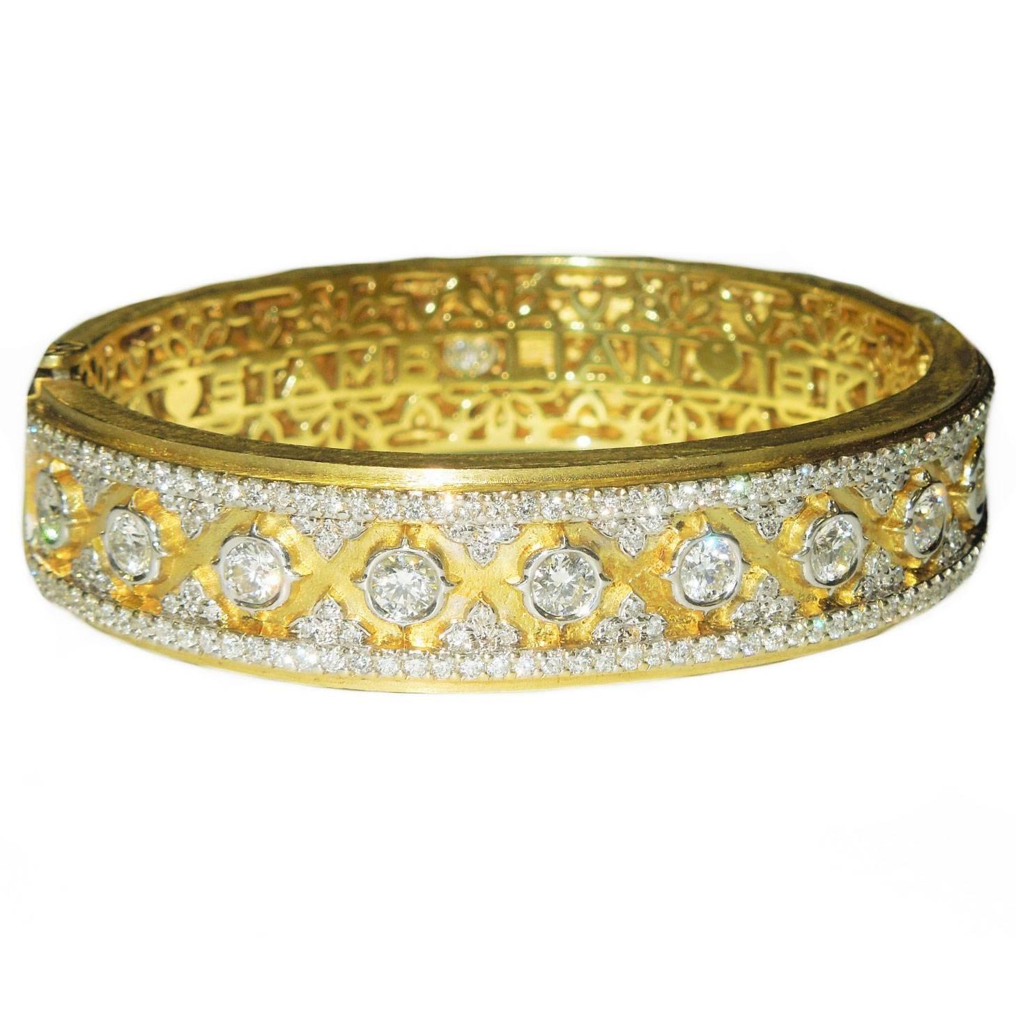 18K Gold Bangle with Diamonds all around

Center stones are 0.25ct. each (10)

Total Diamond weight: 5.22ct.-G Color, VS Quality

Design is seen on entire piece and has a very secure Push Button clasp. 

Signed STAMBOLIAN with our Trademark