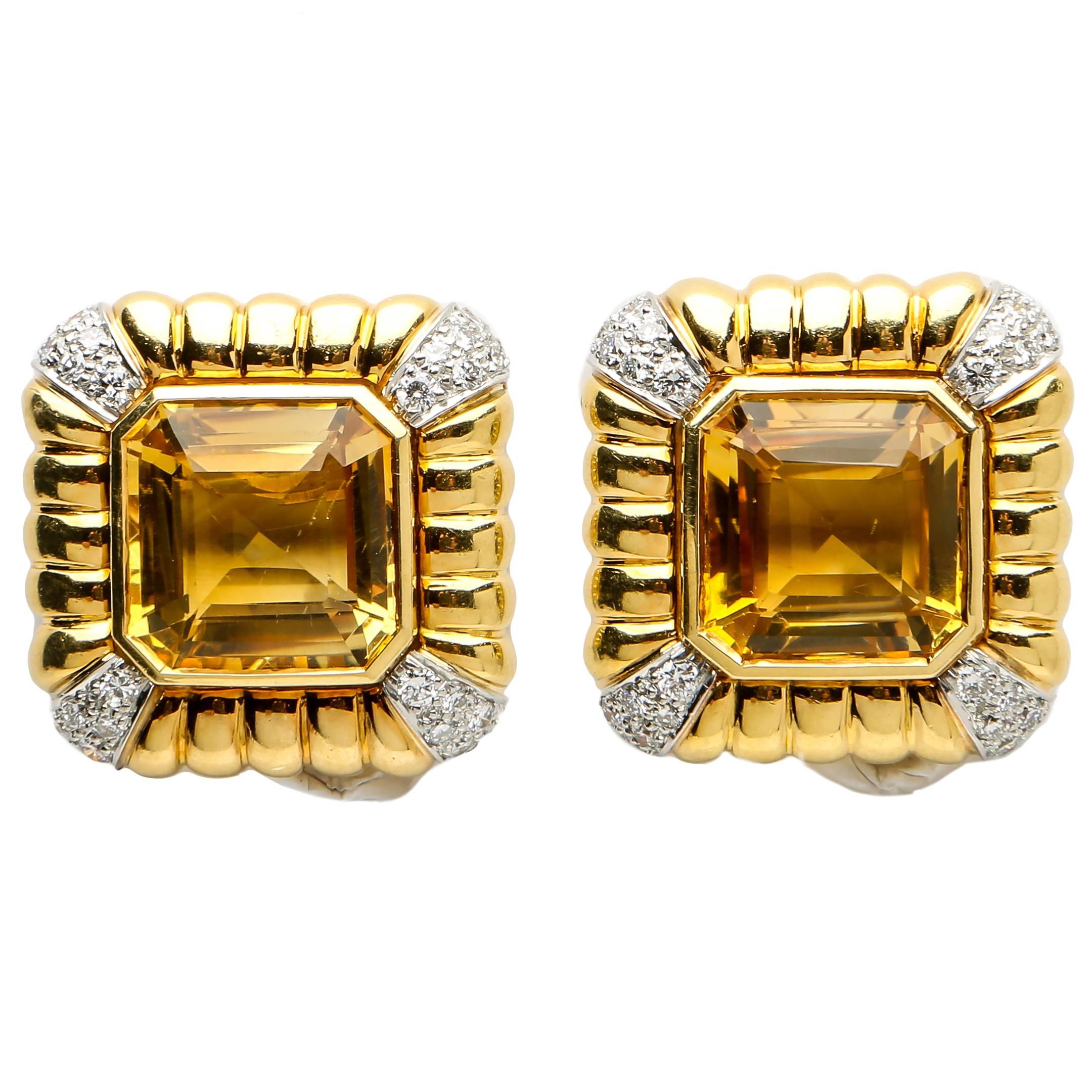 Andrew Clunn's long time affiliation with David Webb shows through in this bold classic design. Bright faceted citrines are set in heavy fluted frames and accented with brilliant cut diamonds. Simply elegant !  7/8's of an inch in size.