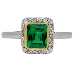 Emerald and diamond cluster ring, circa 1915. 8