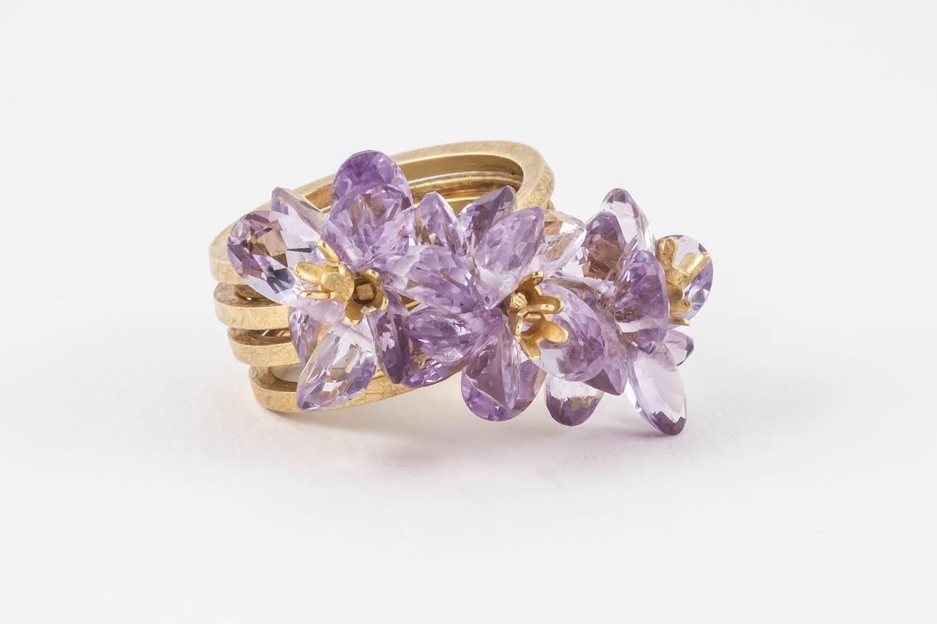 Exquisite Donna Brennan matt 18ct Gold Cocktail Ring featuring an array of Lilac Amethyst stones in a size 6 3/4 - 7 (size N).

Donna's work typically features sculpturally wrapped rings hewn from 18ct Gold, clustered with an assemblage of