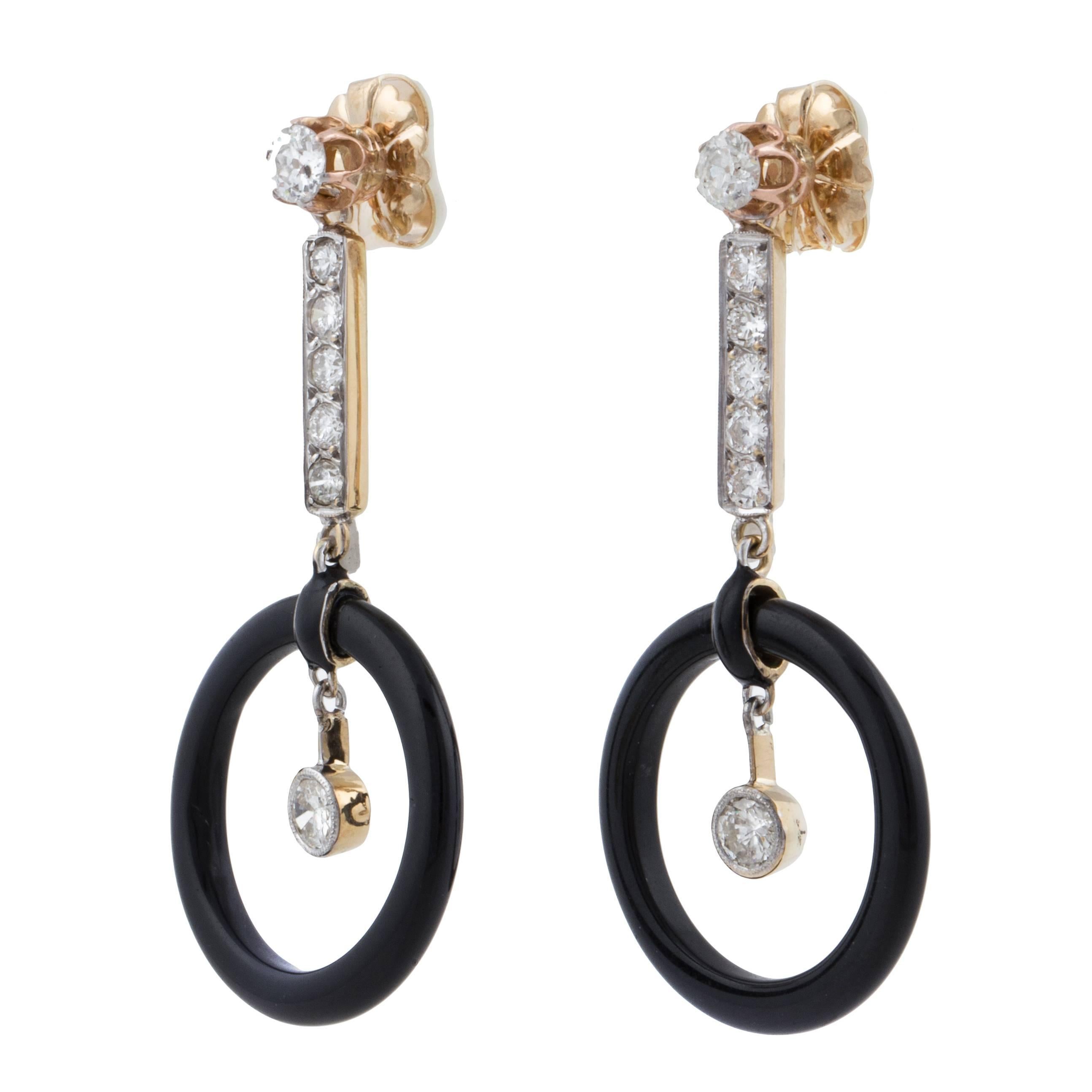 Art Deco concentric drop earrings in 18K yellow gold featuring an onyx disc and diamonds.   There are fourteen round diamonds with a total weight of 2.25 carats, I-J color and VS2-SI1 clarity.  They measure 2 inches long and 7/8 at the widest point.