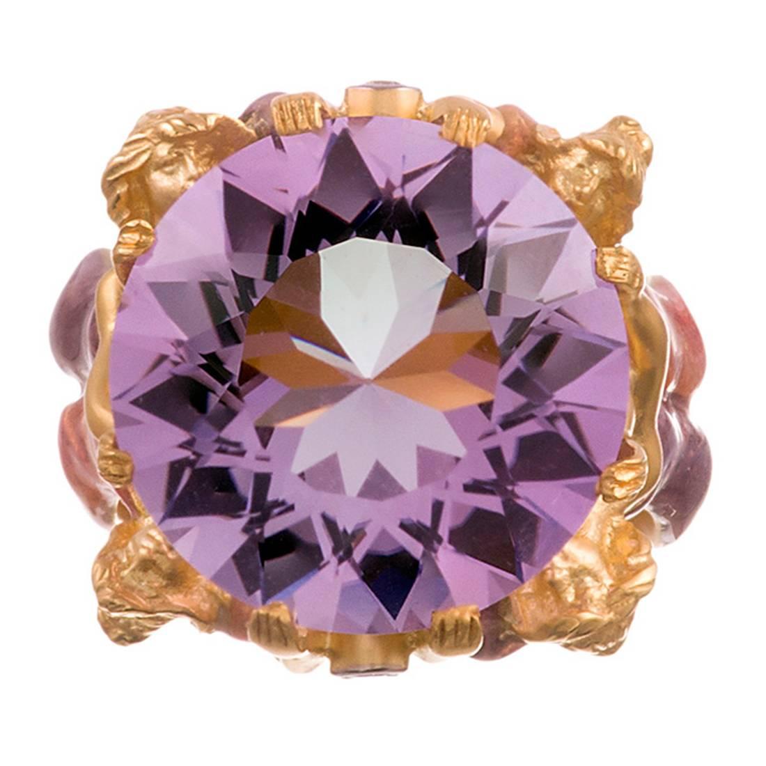 Another ultra-feminie creation, compliments of famed “plaque-a-jour” enamel specialists Masriera. This piece is designed as four nymphs dressed in pink and purple gowns, lifting up and suspending a large round faceted amethyst above their heads. The