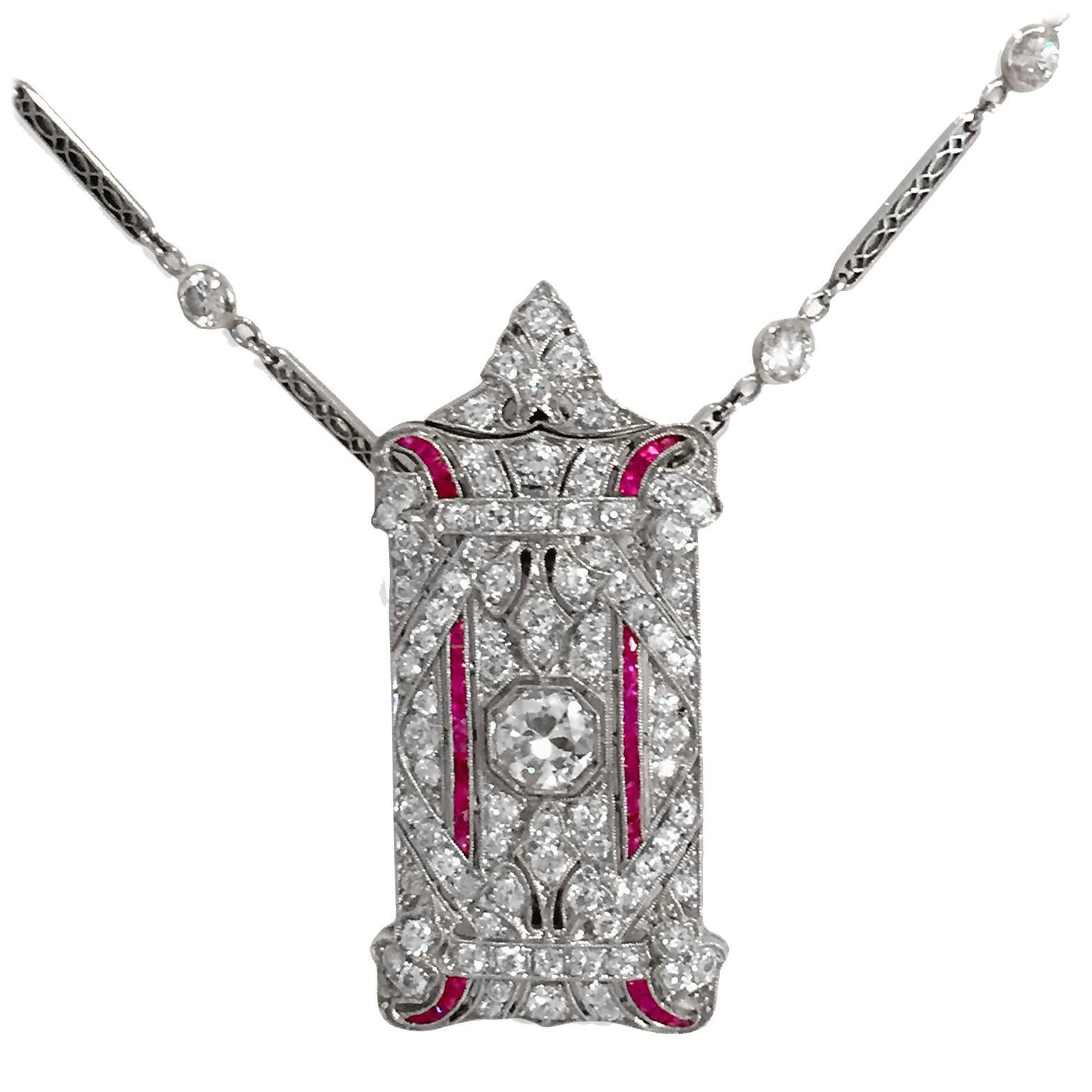 An art deco classic — 4 carats in total of diamonds, with a center old mine-cut diamond of 1 carat H color VS grade, plus an additional 3 carats of diamonds and generous trimmings of princess-cut rubies. Top bail unscrews so the pendant can be worn