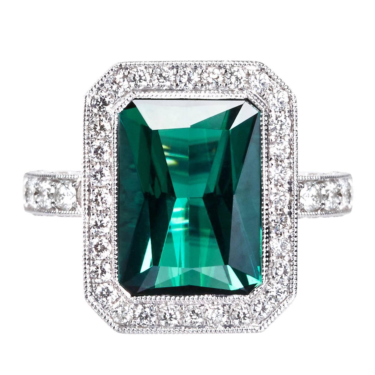 Elegant rectangular mixed cut transparant deep bluish chrome green tourmaline of fine color quality. Hand made one of a kind ring with 124 white brilliant cut diamonds in milgrain setting. Matching earrings available 

Gemstone weight:
1 green
