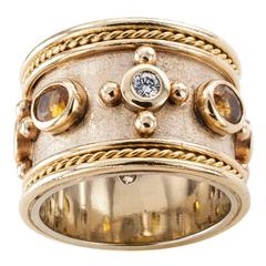 Breiter Goldbandring mit gelbem Saphir und Diamant
