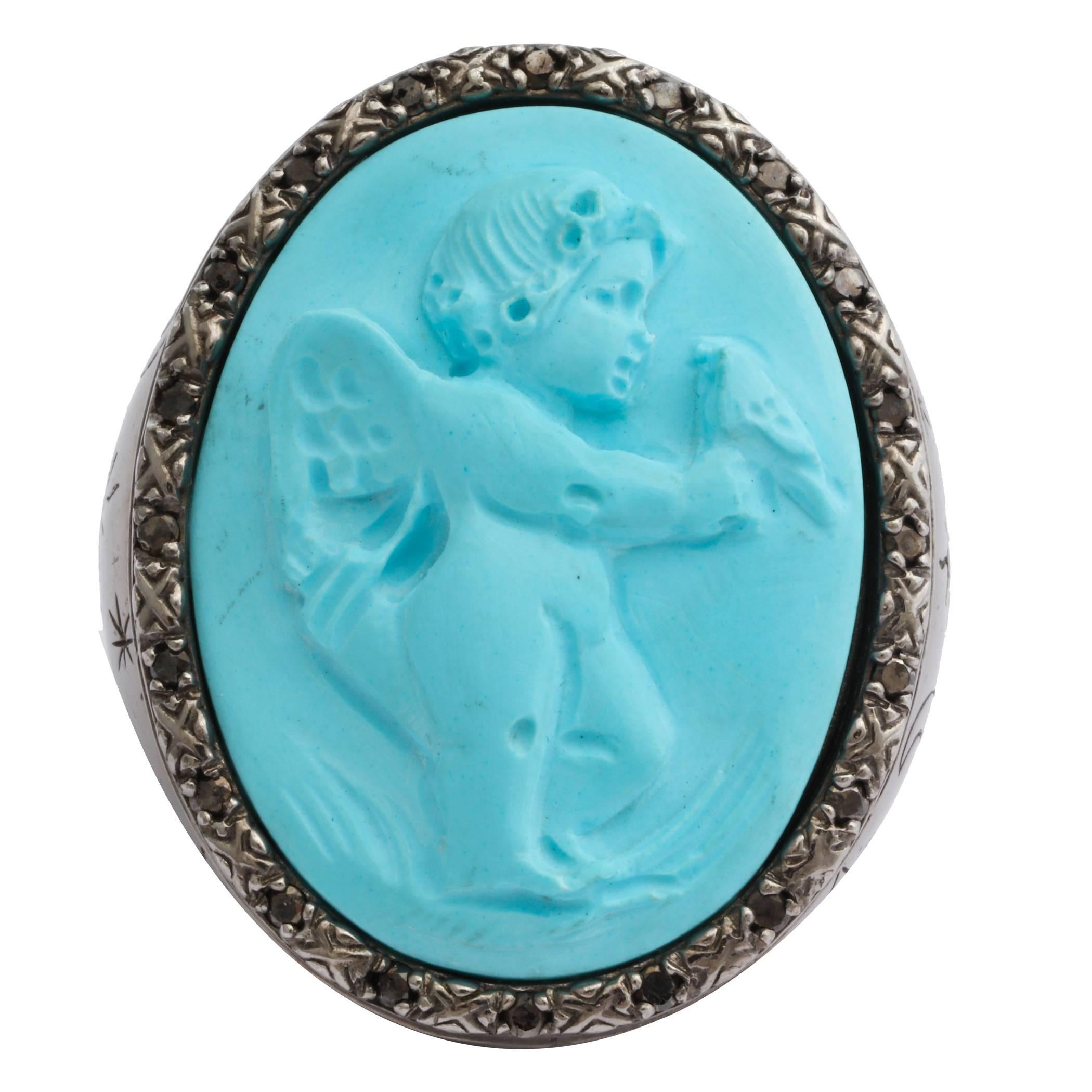 30mm turquoise cameo hand-carved, set in sterling silver black rhodium plated ring with black diamonds.
Ring Size: US7.75

*Being these are hand crafted one of a kind designs, not all ring sizes might be immediately available. We offer custom sizing