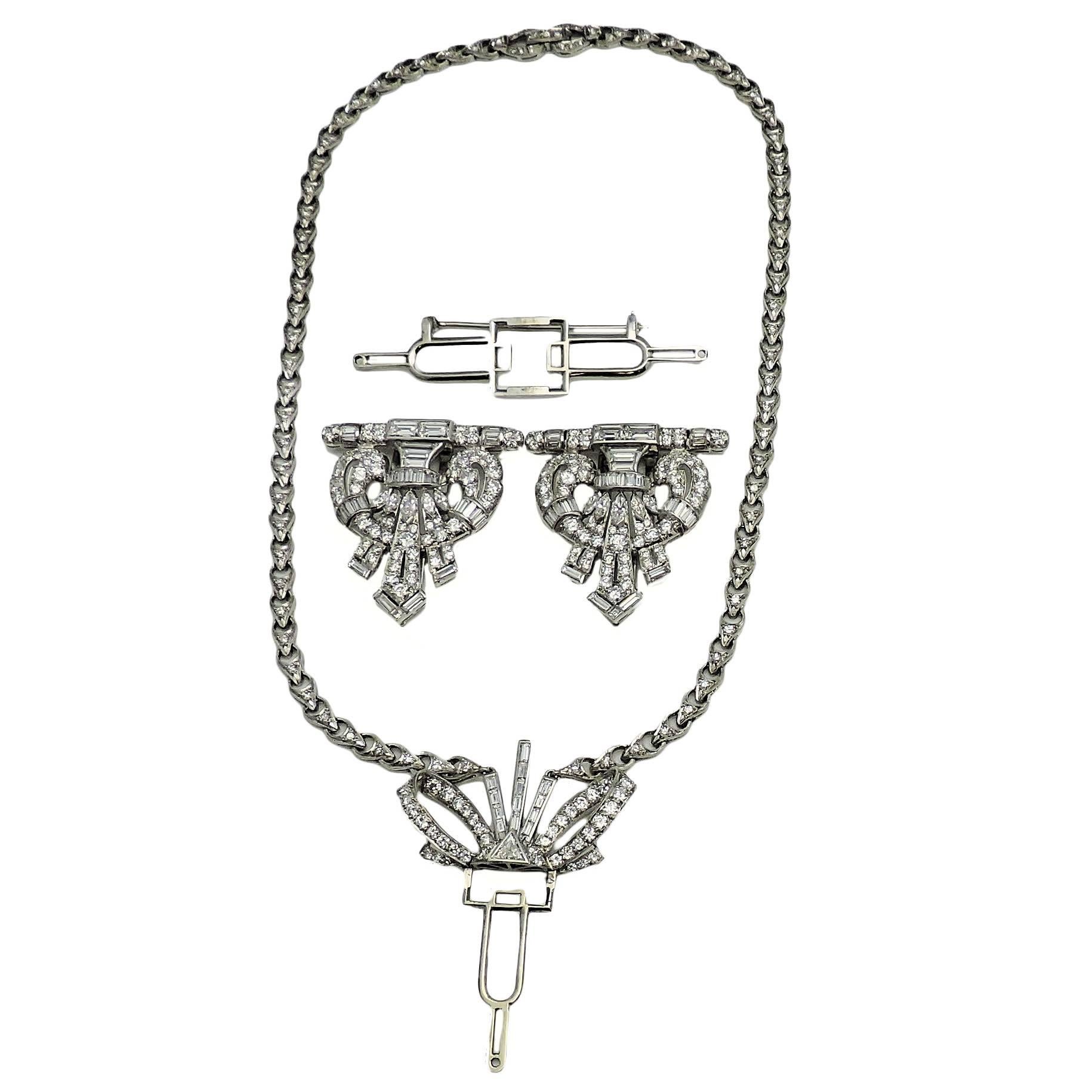 Set with diamonds throughout, this versatile authentic Art Deco period piece converts from brooch to matching dress clips to necklace with quick movements.  Contains 286 round, 80 baguette, 10 marquise, and one triangle cut diamonds with a combined
