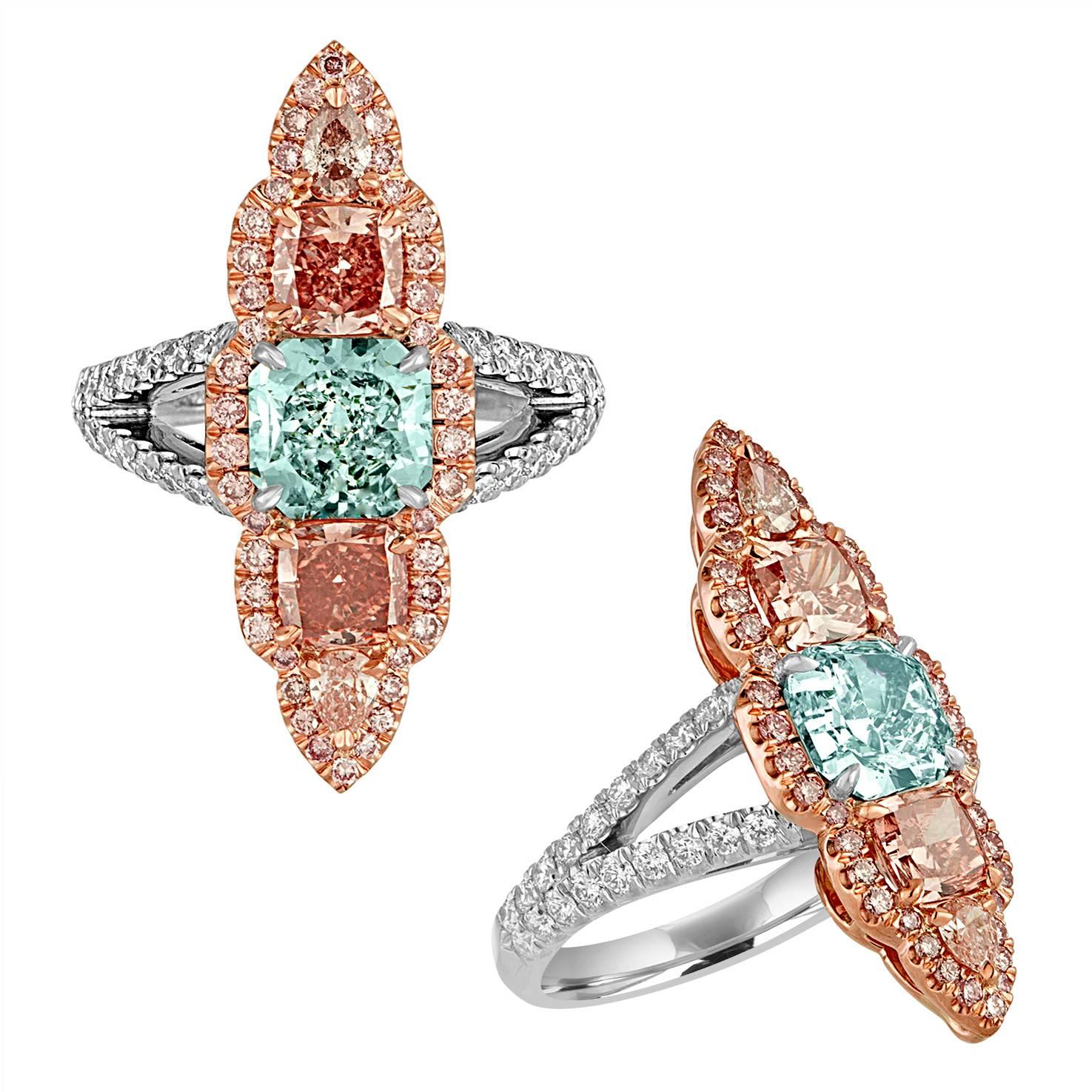 1.57 Carat Cushion GIA Fancy Blue Green in Color and SI1 in Clarity, 0.61 Carat Cushion GIA Certified Fancy Intense Orangey Pink in Color and VS2 in Clarity plus 0.58 Carat Cushion Fancy Deep Orangey Pink in Color and VVS2 in Clarity are set in 18K