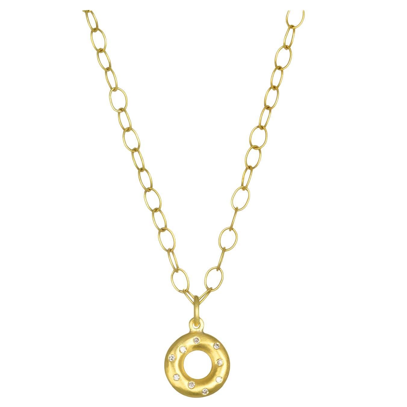 Our favorite Lifesaver flavor is Diamond!
18k Gold Diamond Life Saver Pendant. Total diamond weight is .14 carats. 1/2 inch diameter width. Matte finished.  

Chain Shown.  18K Handmade oval link chain 32