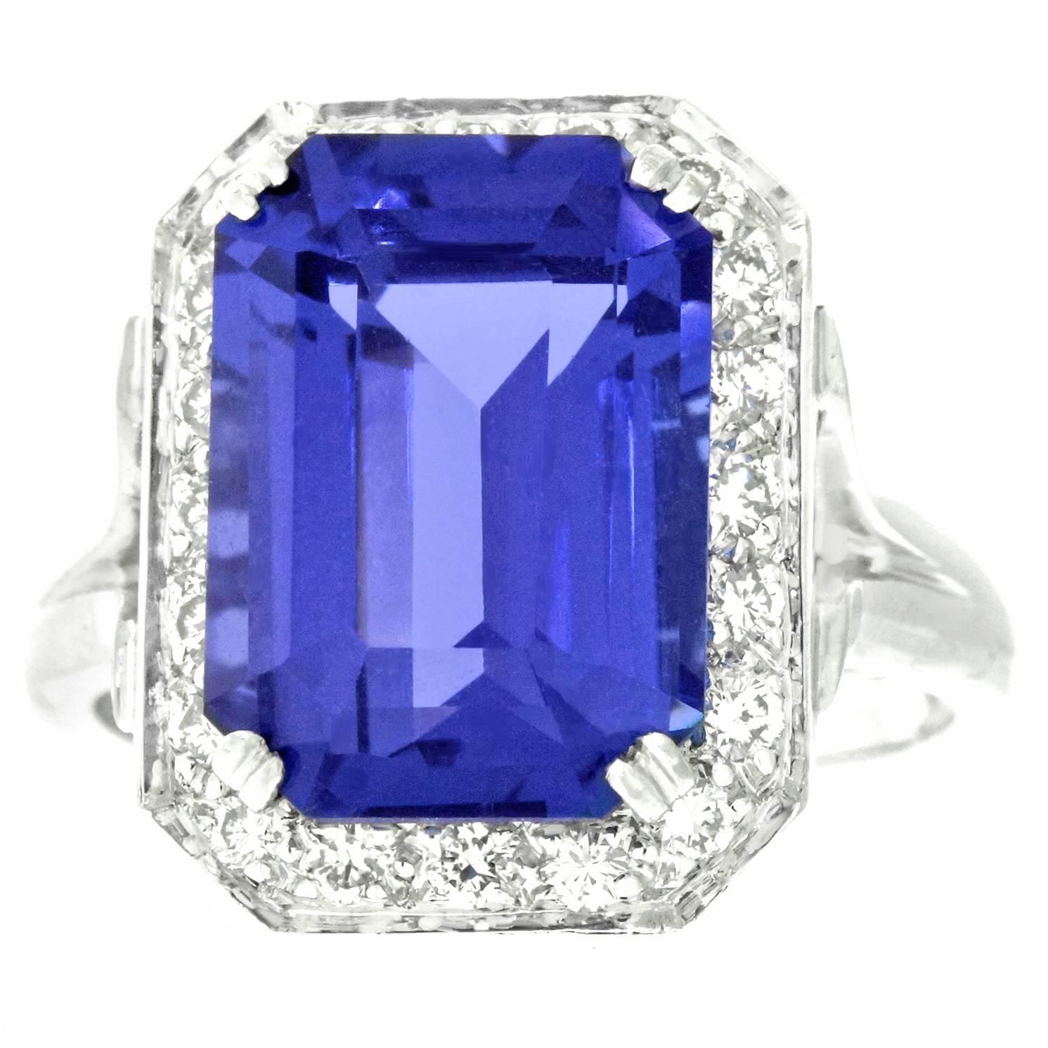 Circa 1980s, 18k, American. This ring is all about the lush 7.0 carat tanzanite. Its brilliant deep lavender blue color and fine clarity are sublime. Additionally set with .48 carats of superb white accent diamonds, this ring features a thoughtful