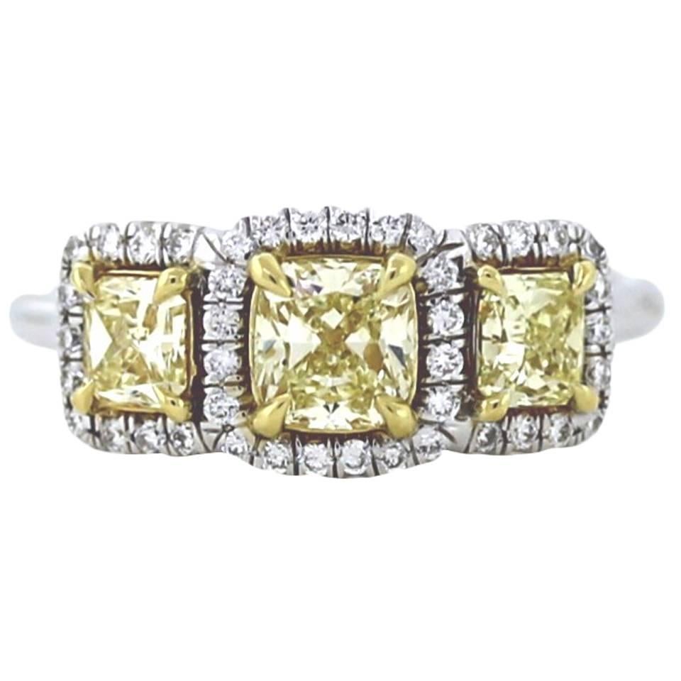 Classic .56 Carat Gia Certified Fancy Yellow Three-Stone Diamond Gold Halo Ring For Sale