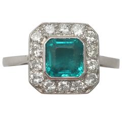 1940s 0.90 Carat Emerald and 0.42 Carat Diamond, Platinum Cluster Ring