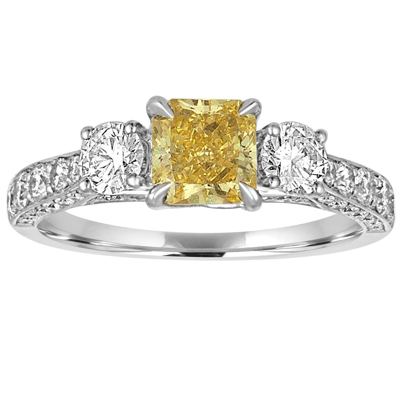 GIA Certified 0.91 Carat Fancy Intense Yellow Diamond Three Stone Gold Ring For Sale