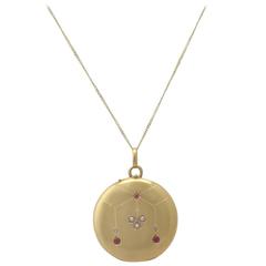 1910s French 0.09 Carat Ruby and Seed Pearl, 18k Yellow Gold Locket