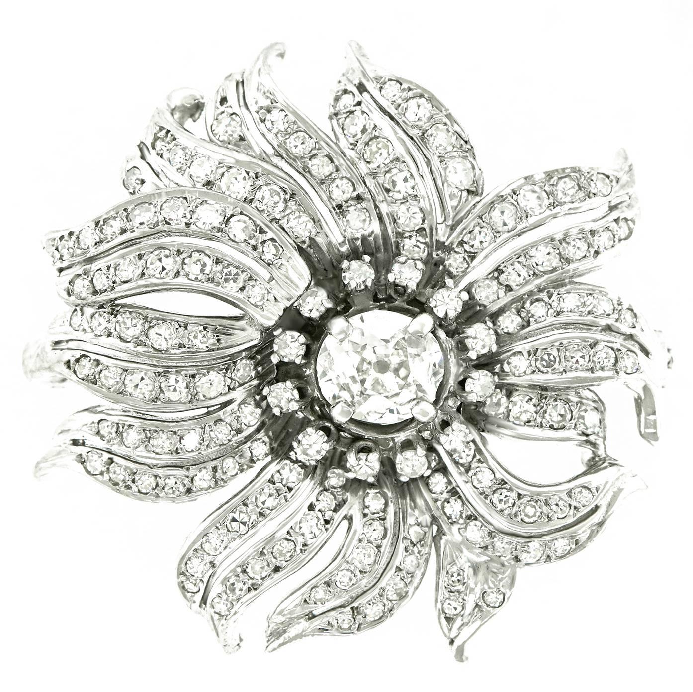 Circa 1920s, 14k, American.  This stunning Art Deco flower brooch features diamond-set petals centered by a .67 carat center stone, for a total of 2.78 carats of brilliant diamonds (H-I color, SI1-2 clarity).  Perfect on a suit, cocktail dress, or