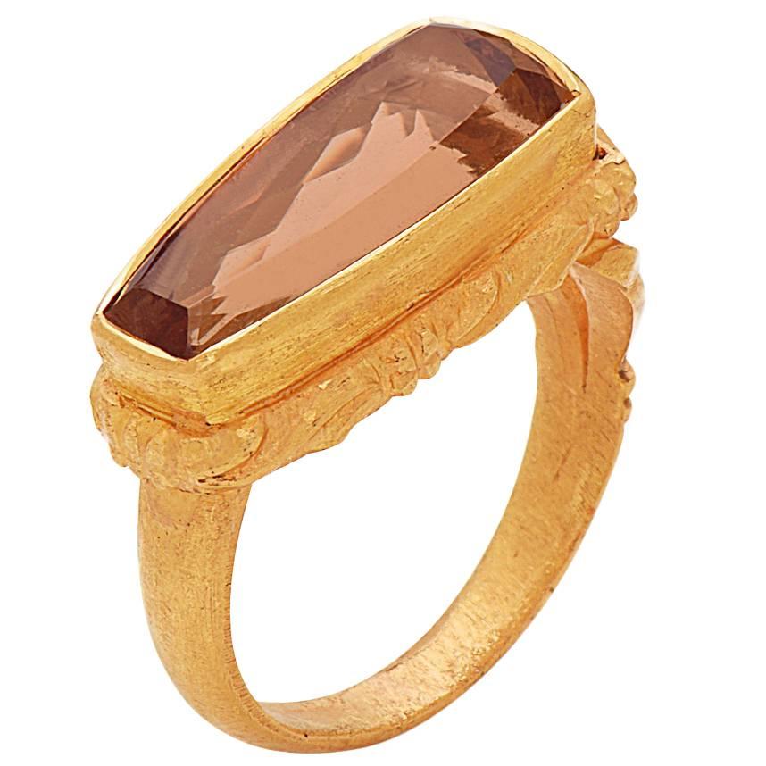 Sweet and sassy Peach Precious Topaz Ring in 22K Yellow Gold with hand carved shank and the rim making it a very unique piece to adorn.

Ring Size: 7 ( Can be sized )

22kt:8.57gm
Precious Topaz:6.35cts
