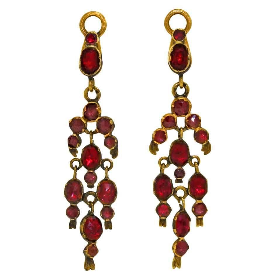Circa 1860s, 18k, France.  These colorful antique chandelier earrings are fabulously chic. The garnets are an exceptional red and the elegant French form is visually seductive. Perfectly at home with casual attire or a cocktail dress, quality