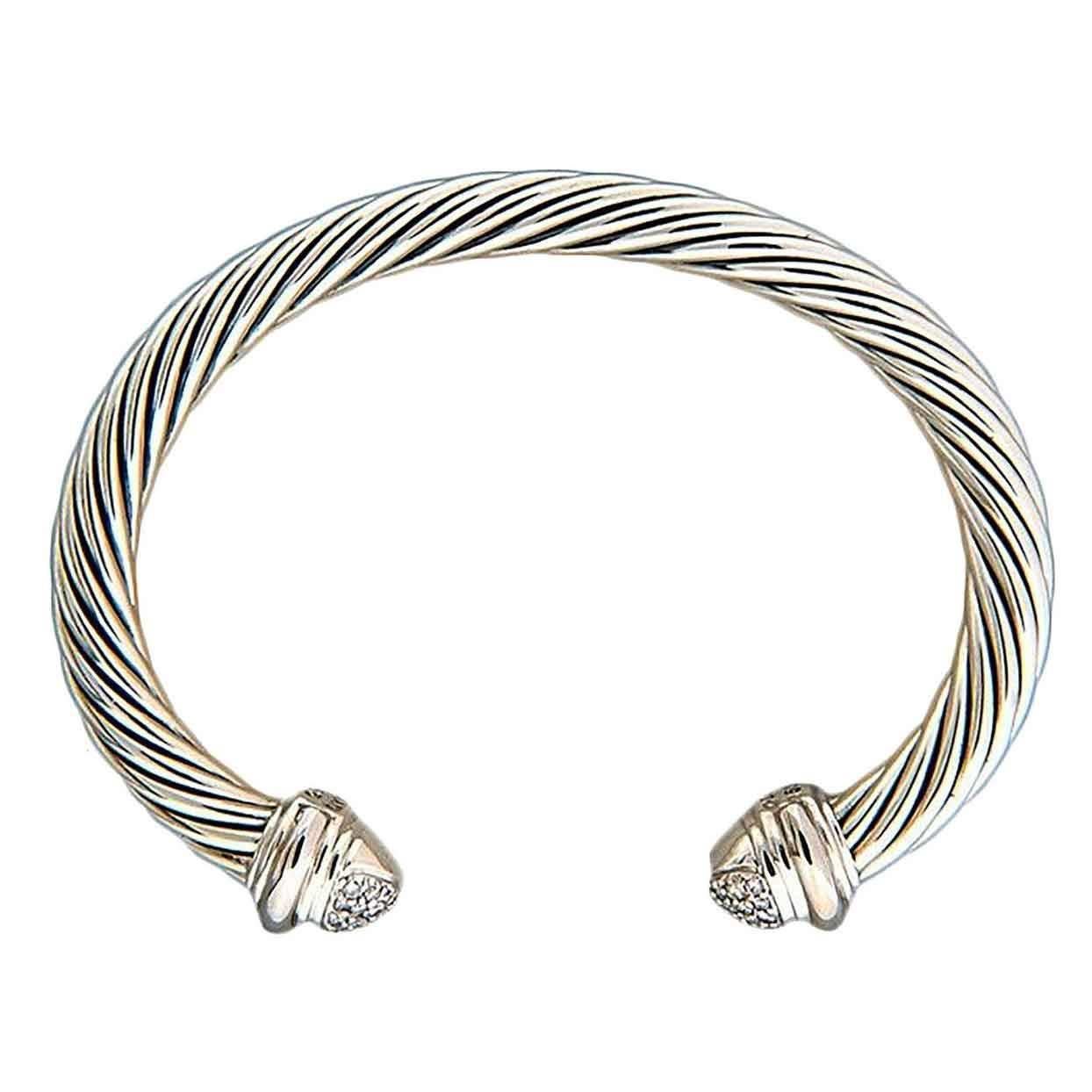 David Yurman 7mm silver cable bracelet with 18k white gold diamond end caps.

40 full cut diamonds, approx. total weight .55cts, H, SI1
18k white gold caps
Silver
43.26 grams
7mm silver cable bracelet
Stamped: D Yurman 750 925
Oval shape 2.55 x 1.7