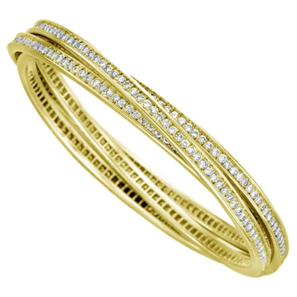 Echoing the infinite bounds of true romance, Diamonds grace the full length of each of these 18k Yellow Gold Trinity Bangles, forming a never-ending loop of incomparable brilliance. The Diamonds total a stunning 6.45ct between all 3 Bangles,