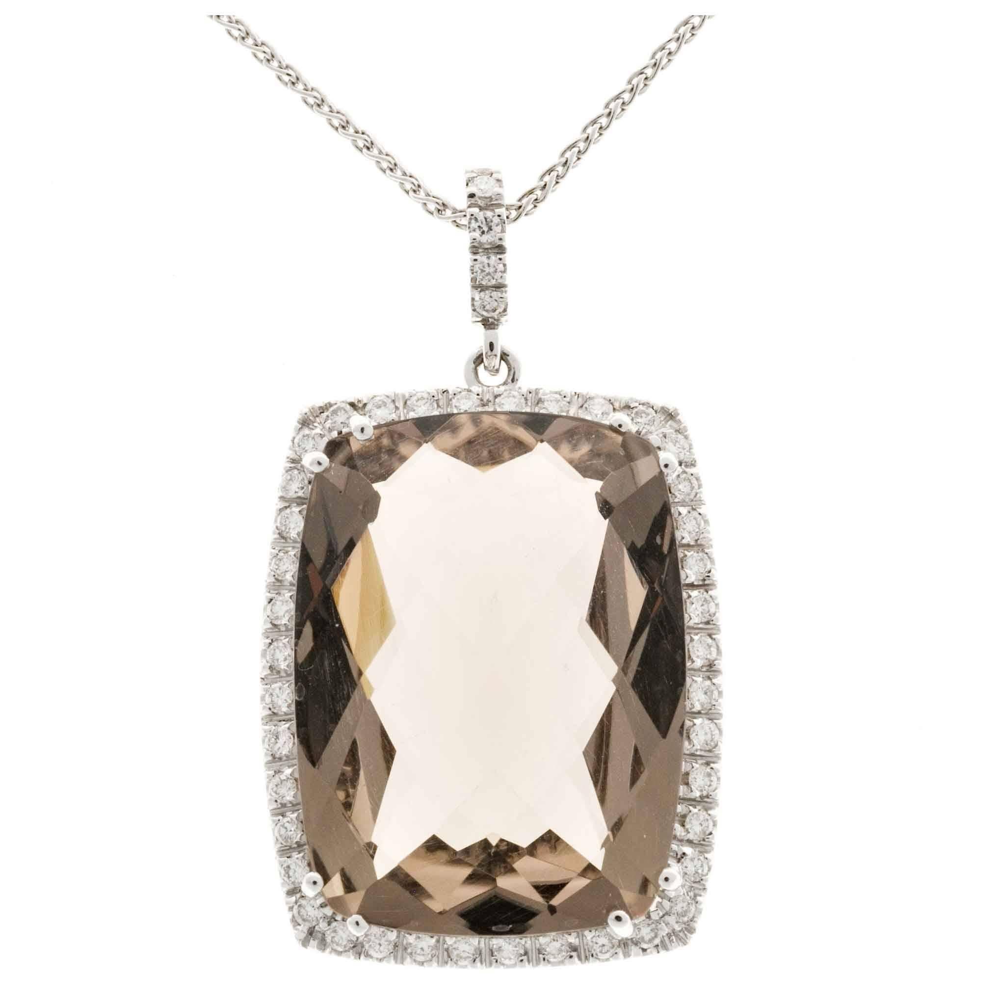 Smoky quartz diamond pendant necklace. 24.00ct cushion cut quartz with a halo of 46 round cut diamonds. 16 inch white gold wheat chain.

1 cushion smoky Quartz, approx. total weight 24.00cts, natural color
46 round diamonds, approx. total weight
