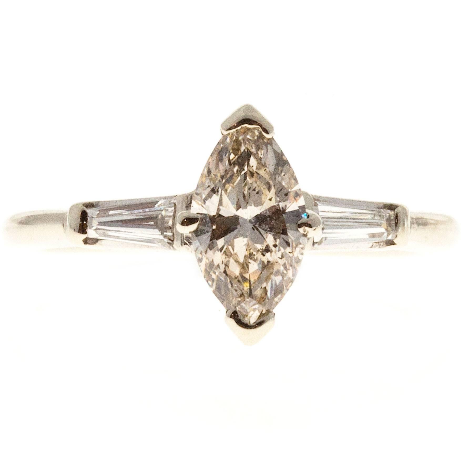Natural faint brown Ideal cut Marquise and baguette diamond three-stone engagement ring. 14k white setting. All original 1950-1959. 

1 Marquise diamond approx. total weight .69cts, GIA certificate # 2125012813 Ideal cut. Depth: 60.2% Table: 61%.