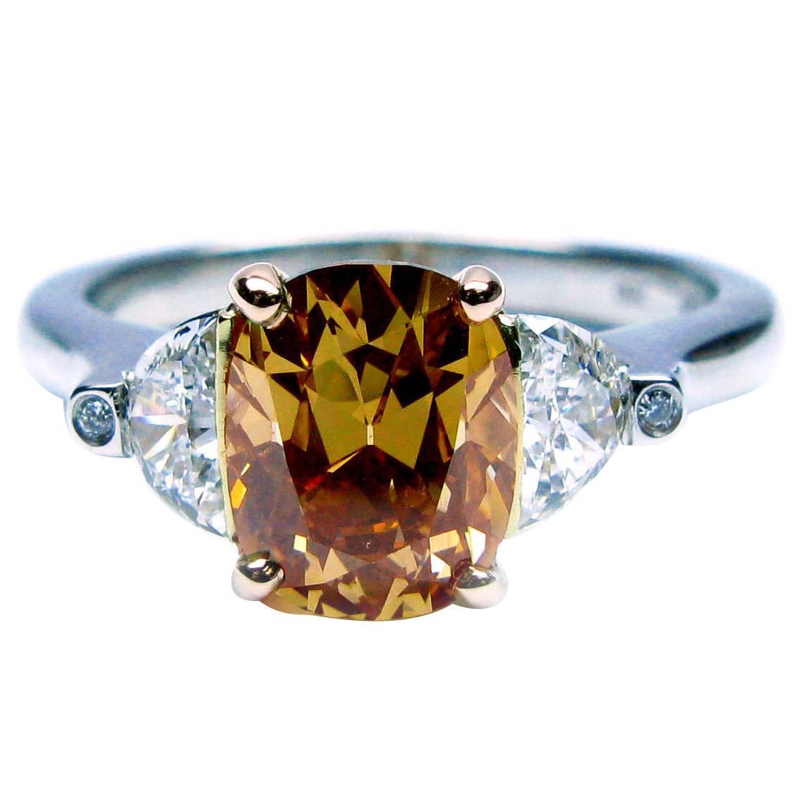 J. Birnbach 1.57 carat Fancy Brown-Orange Cushion Diamond Three Stone Ring For Sale