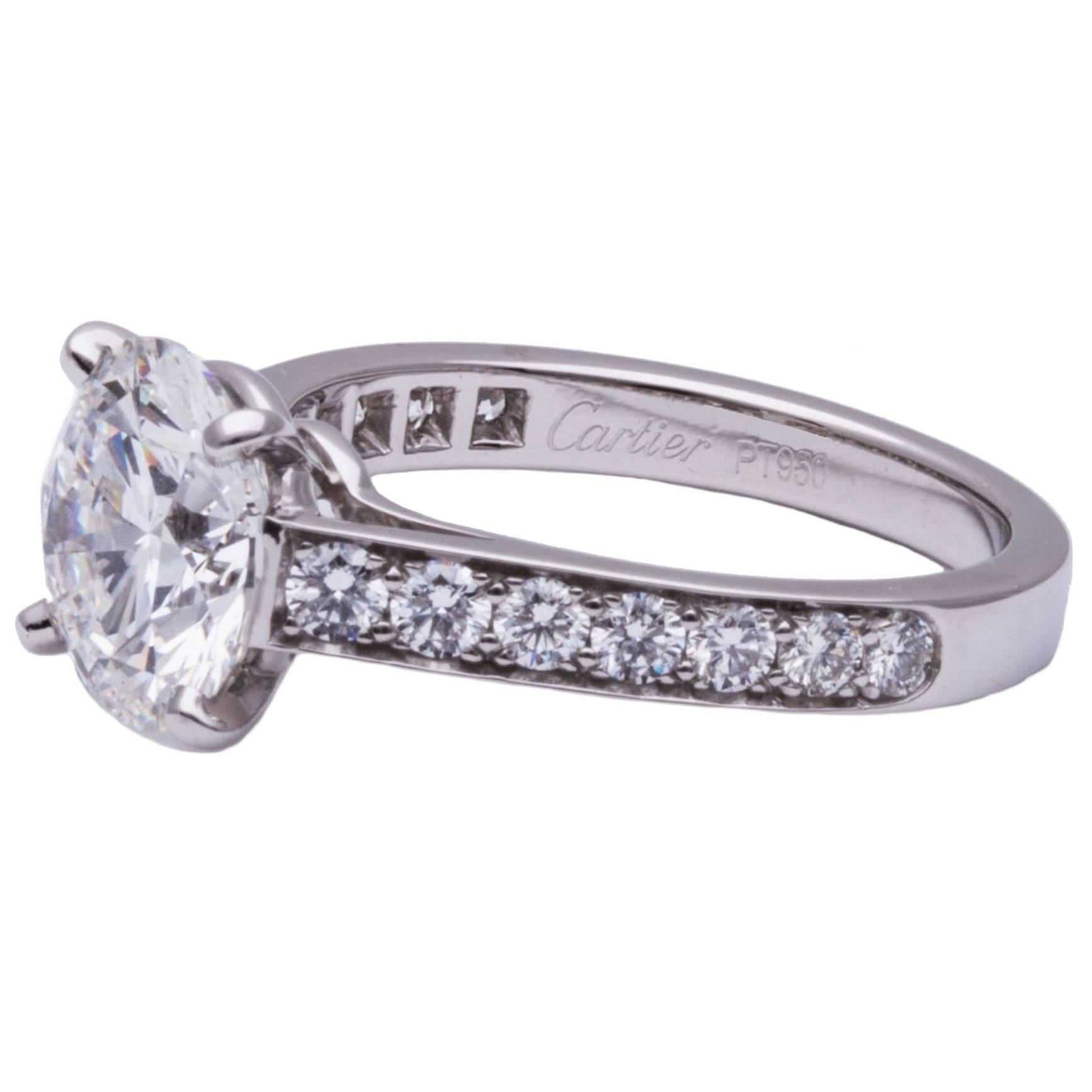 Cartier diamond ring/ Engagement ring in platinum, Center stone 3.04ct. F/ VVS2 GIA Certified Round Diamond, Total (14) brilliant cut diamond side stones on the shank/ (7) on each side of the center stone, Size US 7 1/8 / EUR 55, Signed: 