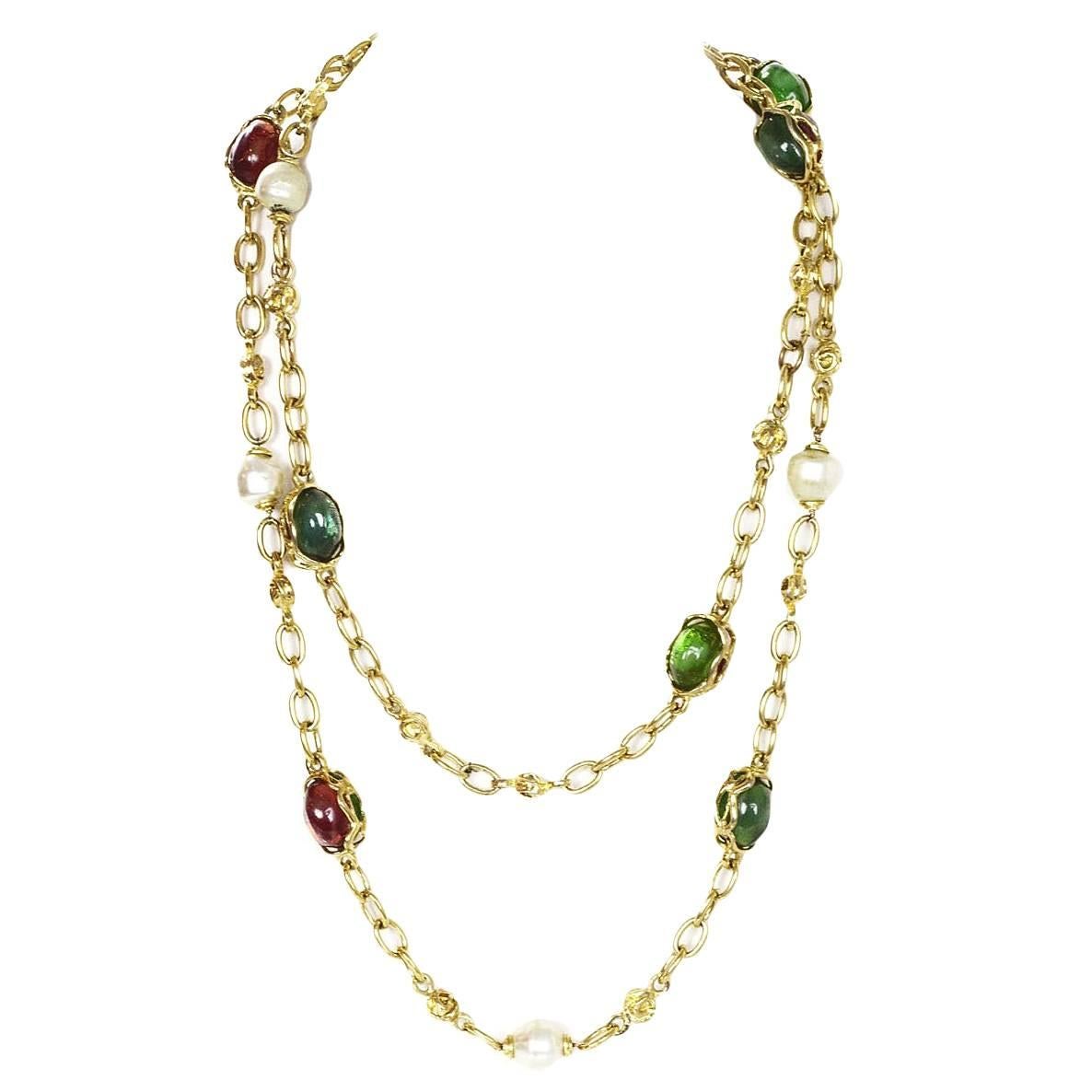 100% Authentic Yves Saint Laurent Faux Pearl And Glass Necklace. Gold chain link necklace features faux pearls, green and amber glass beads. Jump ring clasp with YSL logo. Excellent pre-owned condition with the exception of scuffs and marks on