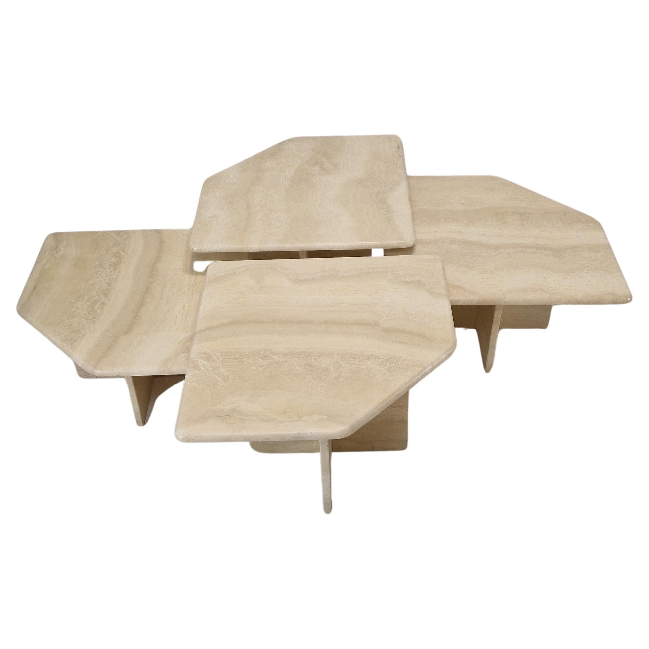 Stunning set of 4 Italian coffee or side tables, handcrafted out of travertine. 
They can be used inside or outside the house.

The tables all have a different height so they fit under each other. 

The plate and the base are made of beautiful