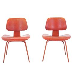 Pair of Eames DCW's, Red Aniline Dyed Ash Plywood, Original